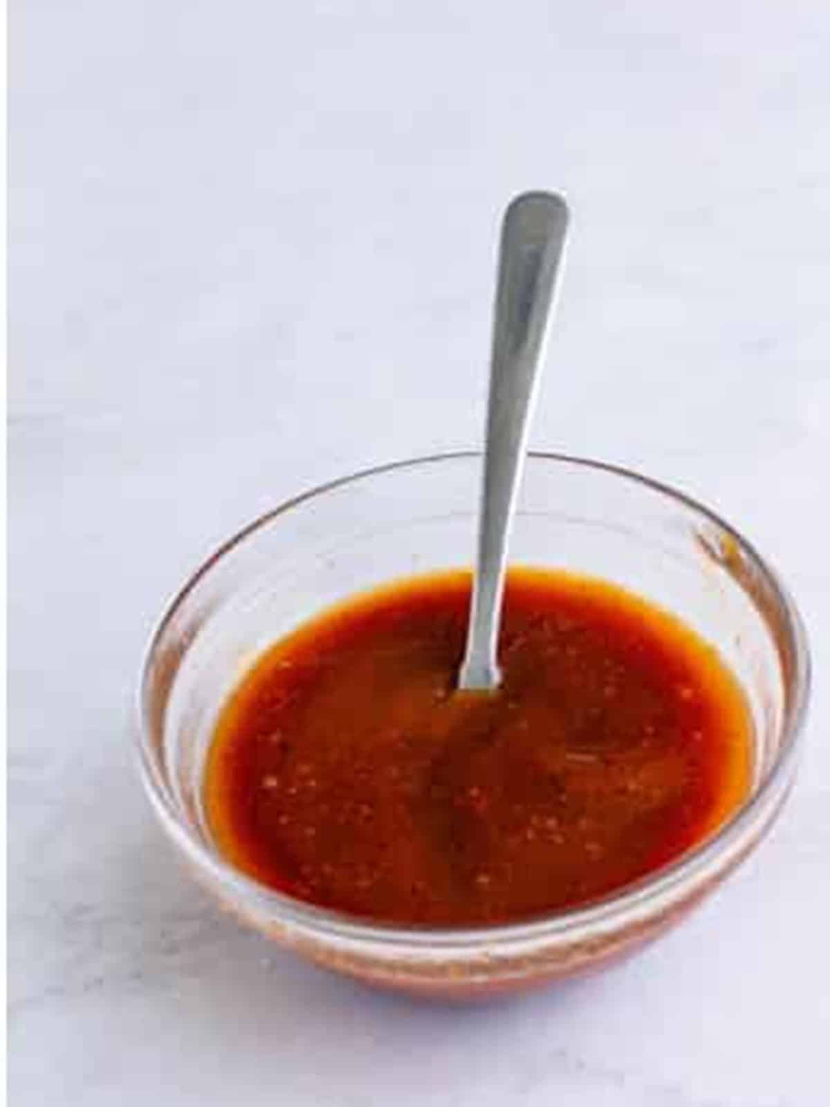 BBQ sauce and beer stirred together in a small bowl.