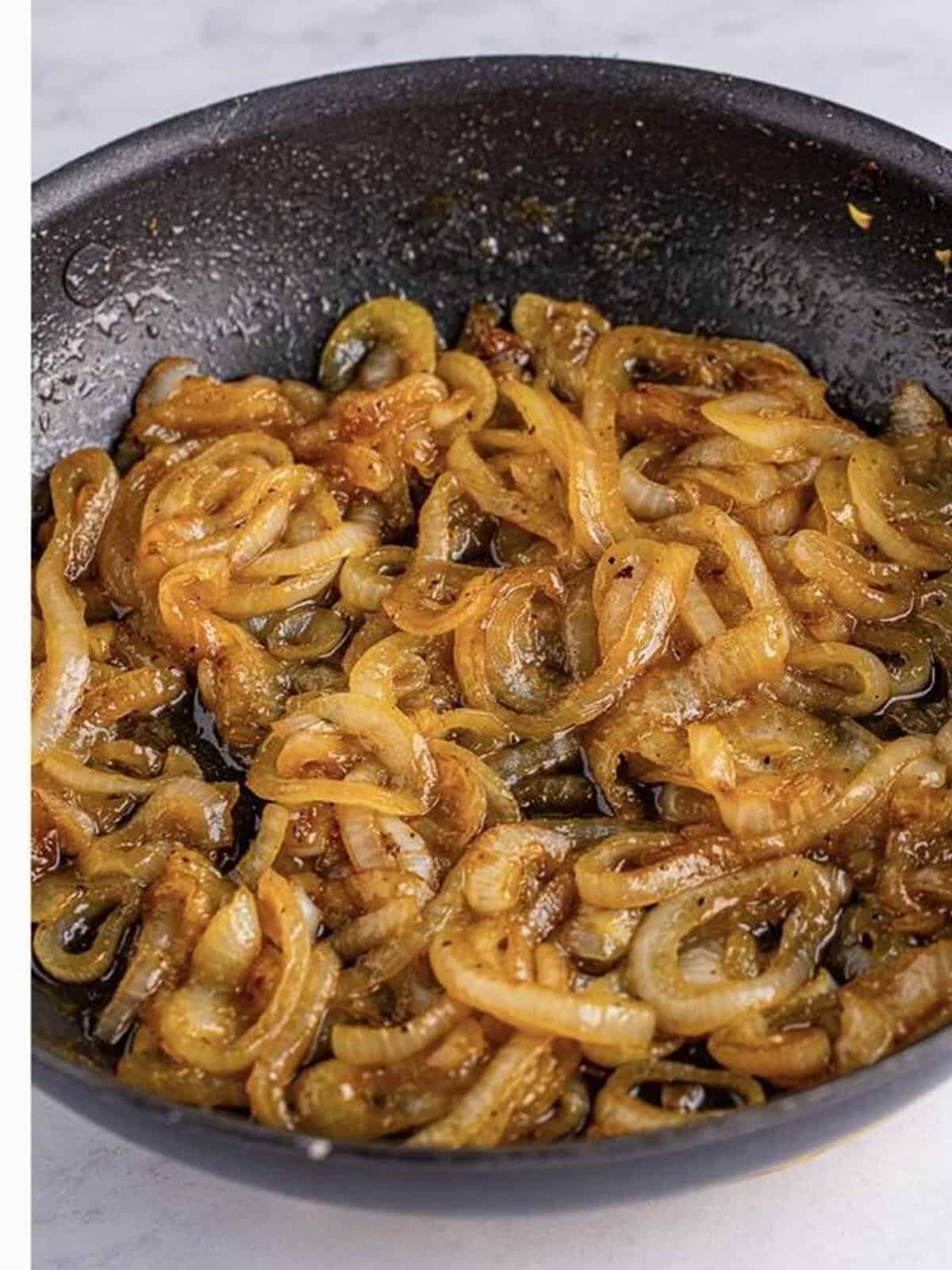 Sweet onions caramelizing in beer and brown sugar in the skillet for the brats.