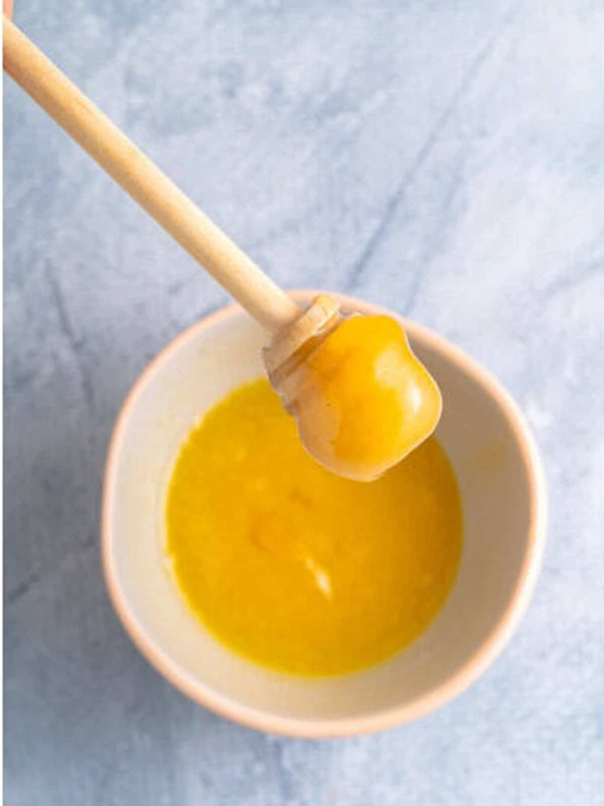 Melted butter and honey whisked together in a small bowl to brush over bacon wrapped dates.