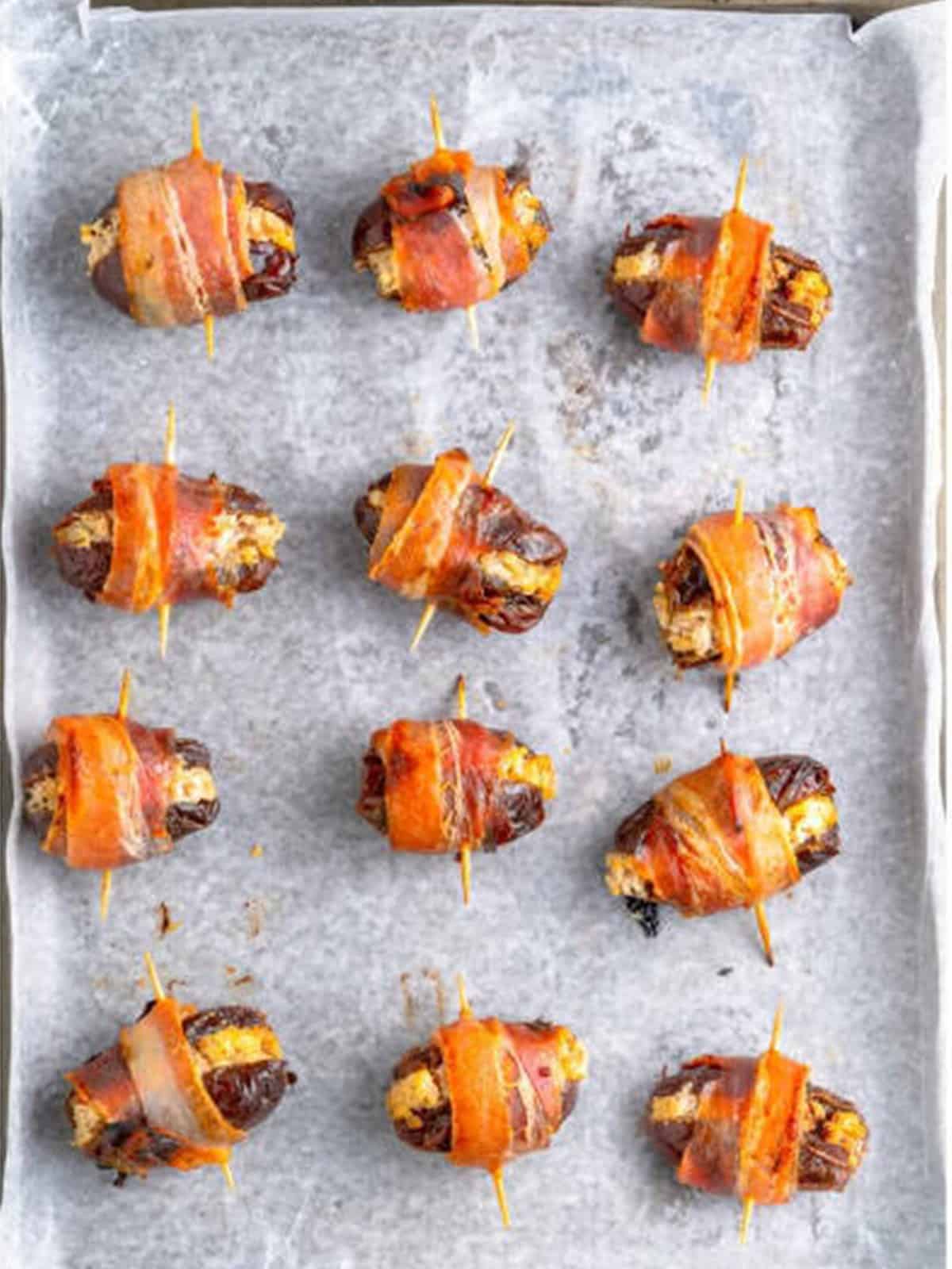 Baked bacon wrapped dates with crispy bacon fresh from the oven.