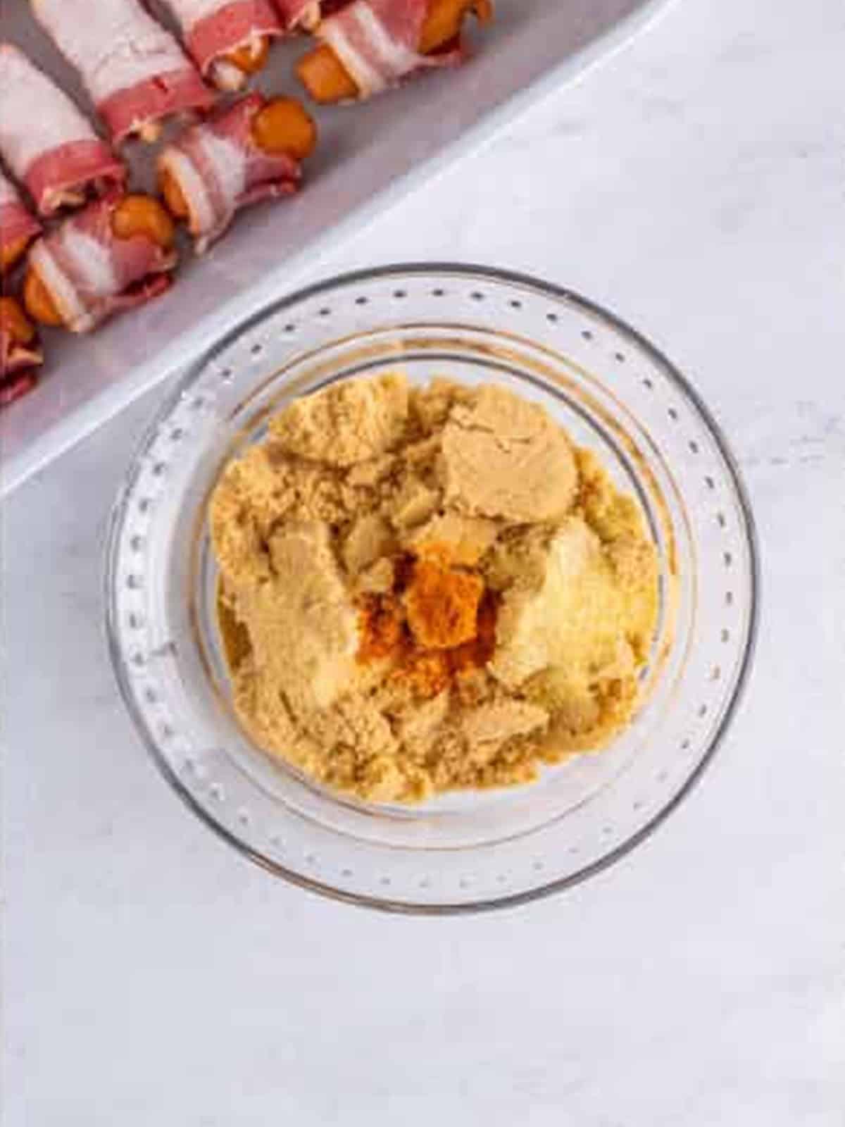 Brown sugar, garlic powder, onion powder, and cayenne in a bowl.