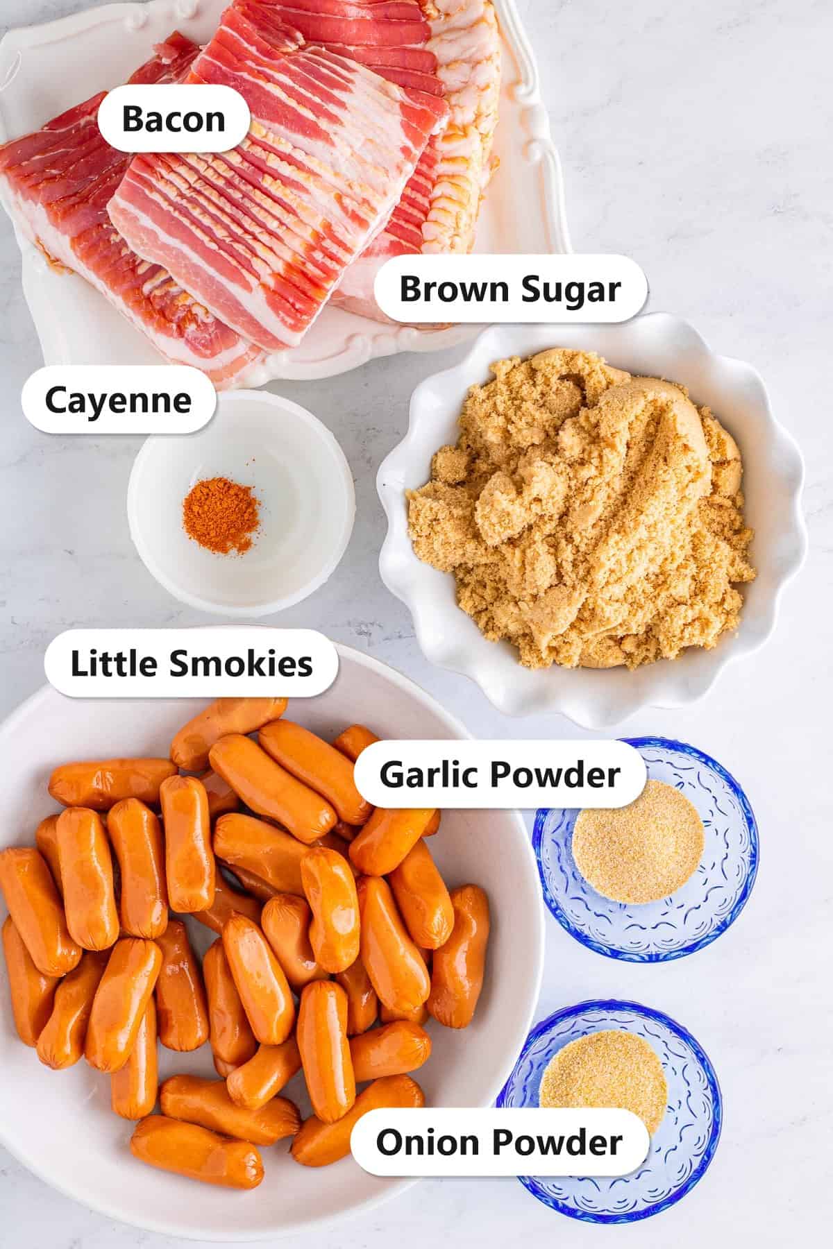 Bacon Wrapped Little Smokies ingredients including bacon, little smokies, brown sugar, garlic powder, onion powder, and cayenne labeled on a counter.