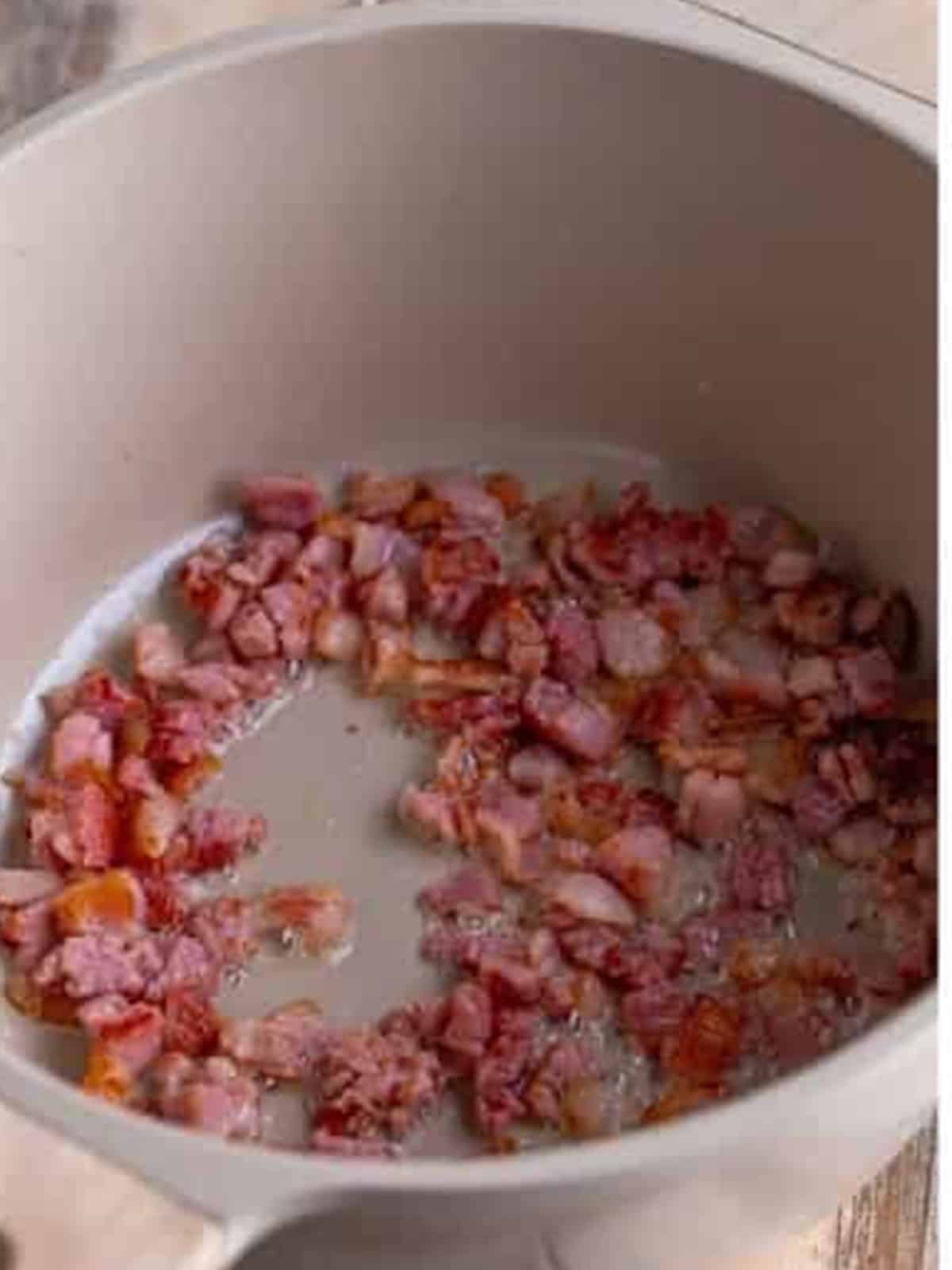 Diced salt pork rendering in a Dutch oven to start baked beans recipe.