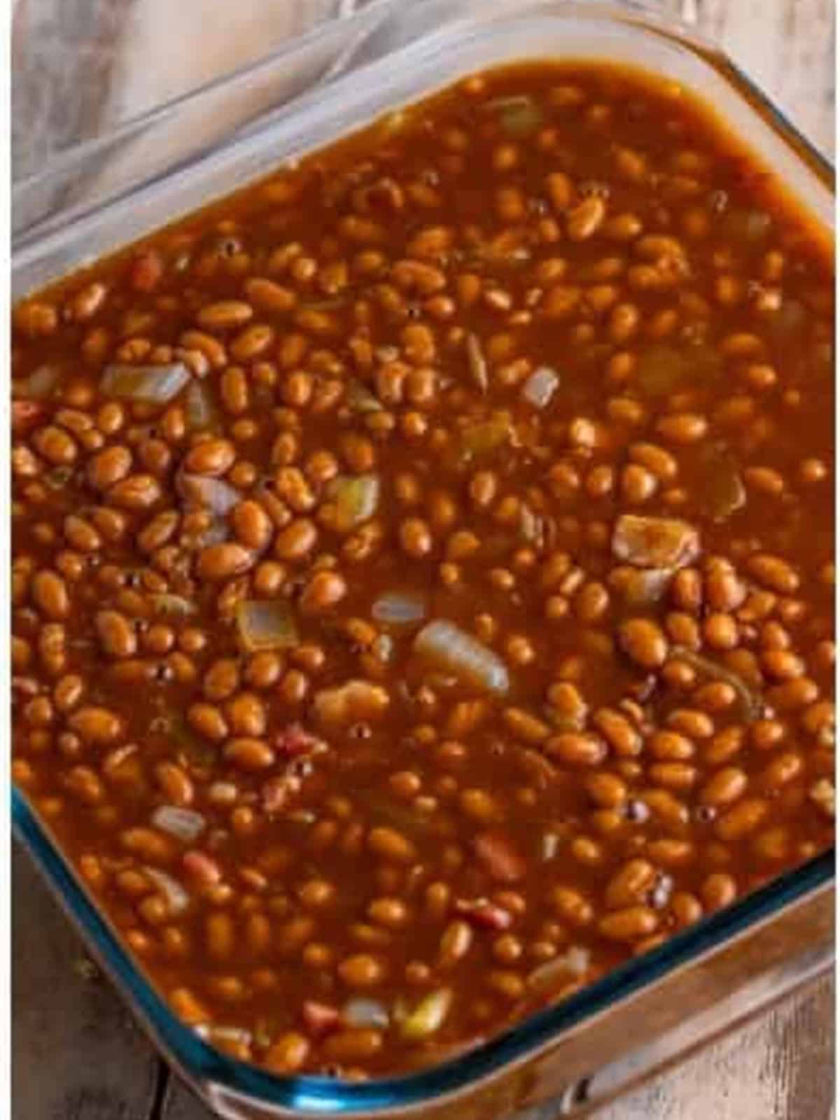 Baked beans mixture poured into a glass baking dish before baking.