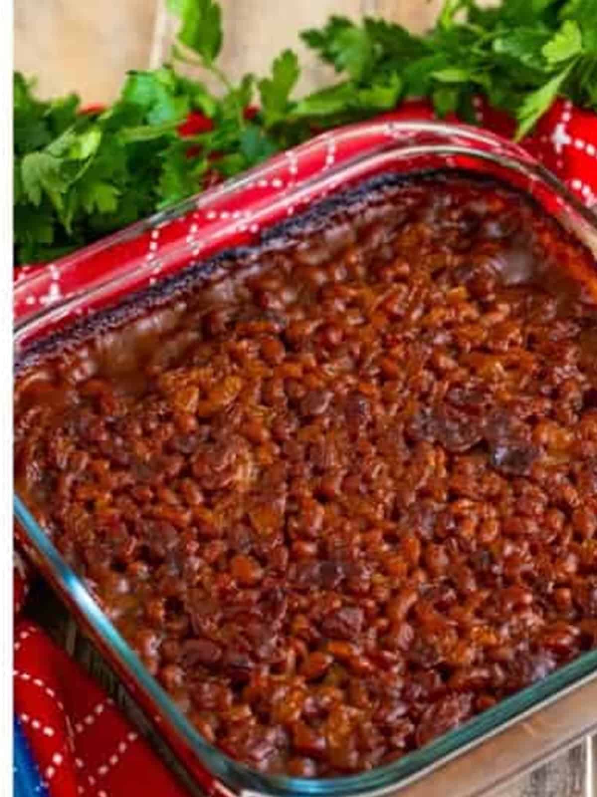 Baked beans baked until the top is caramelized and sticky in a baking dish.