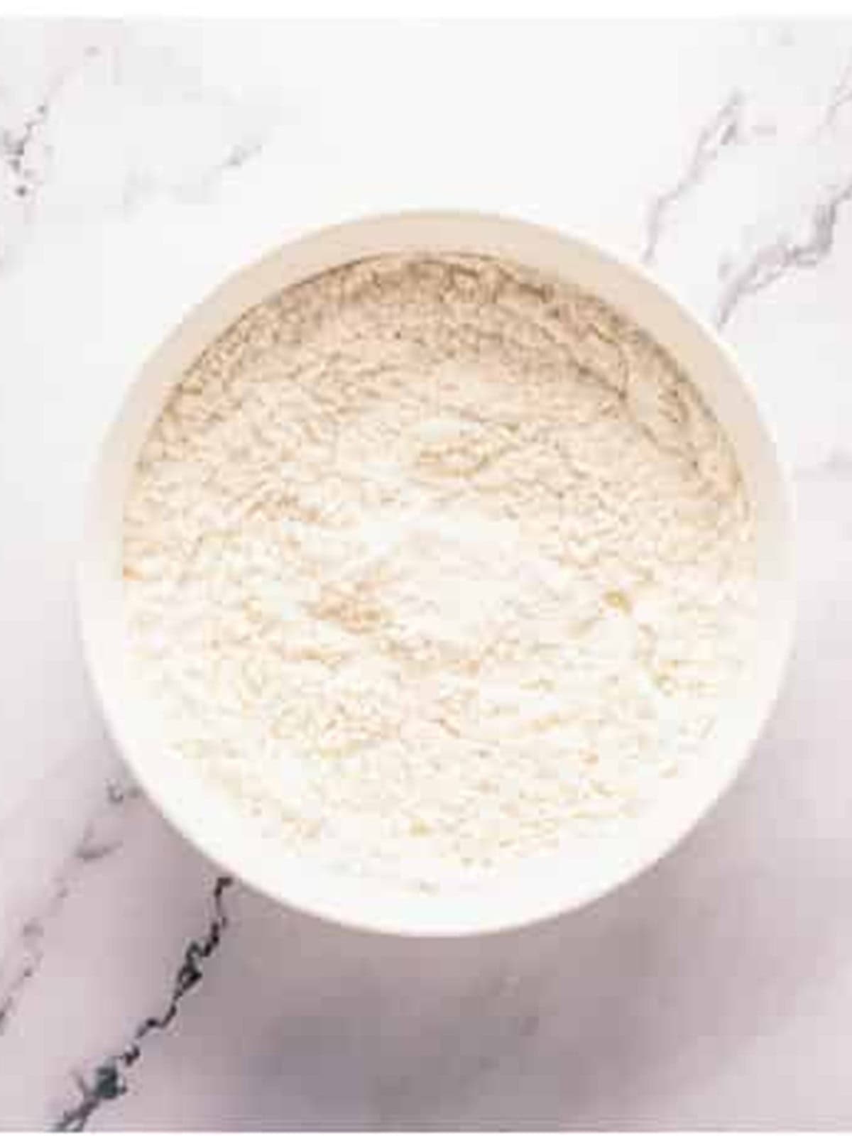 Flour, baking powder, and salt in a bowl for baked donut holes.