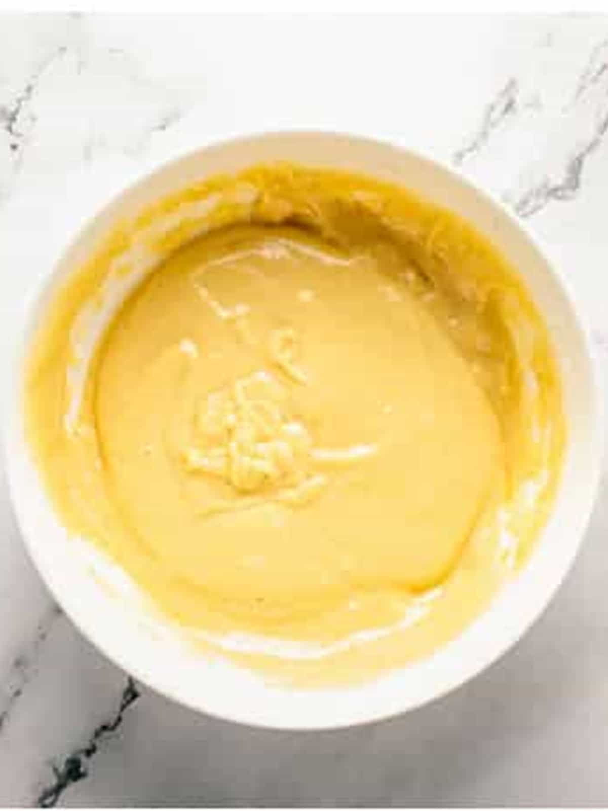 Smooth donut hole batter in a white bowl.