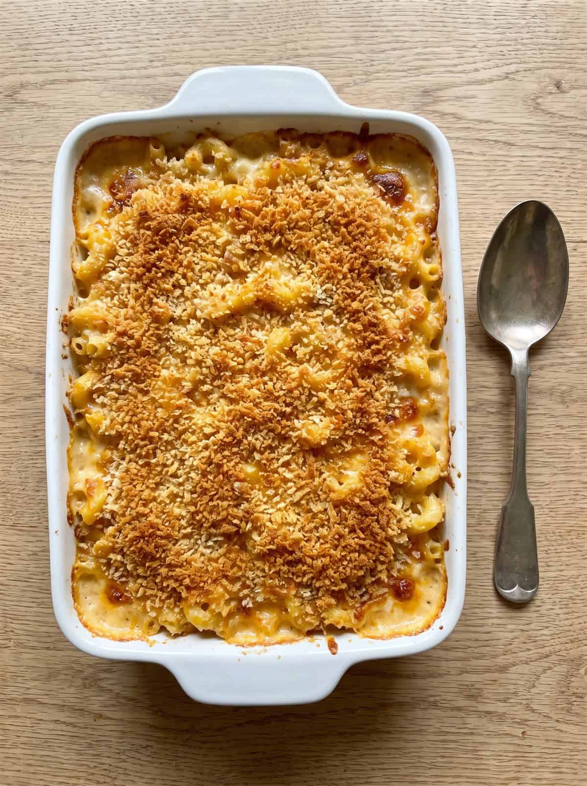 A baking dish of baked mac and cheese with a crispy golden panko breadcrumb crust.