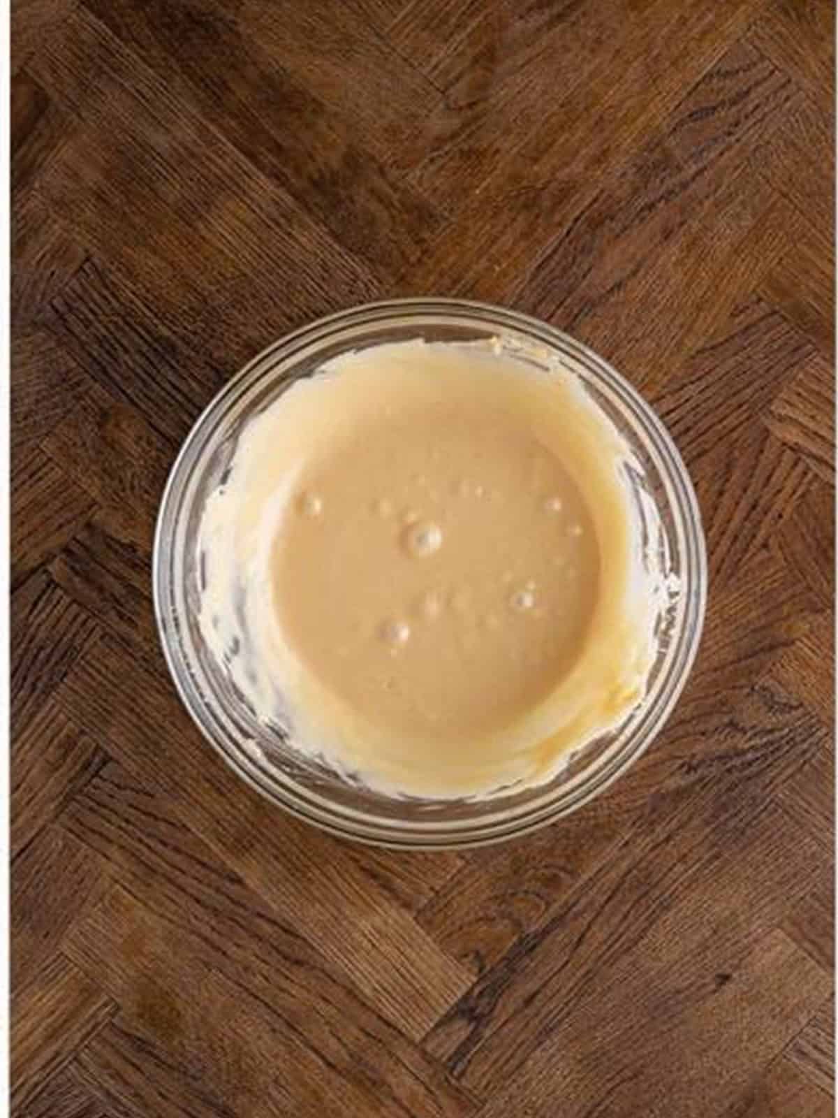Smooth peanut butter glaze whisked together in a bowl.