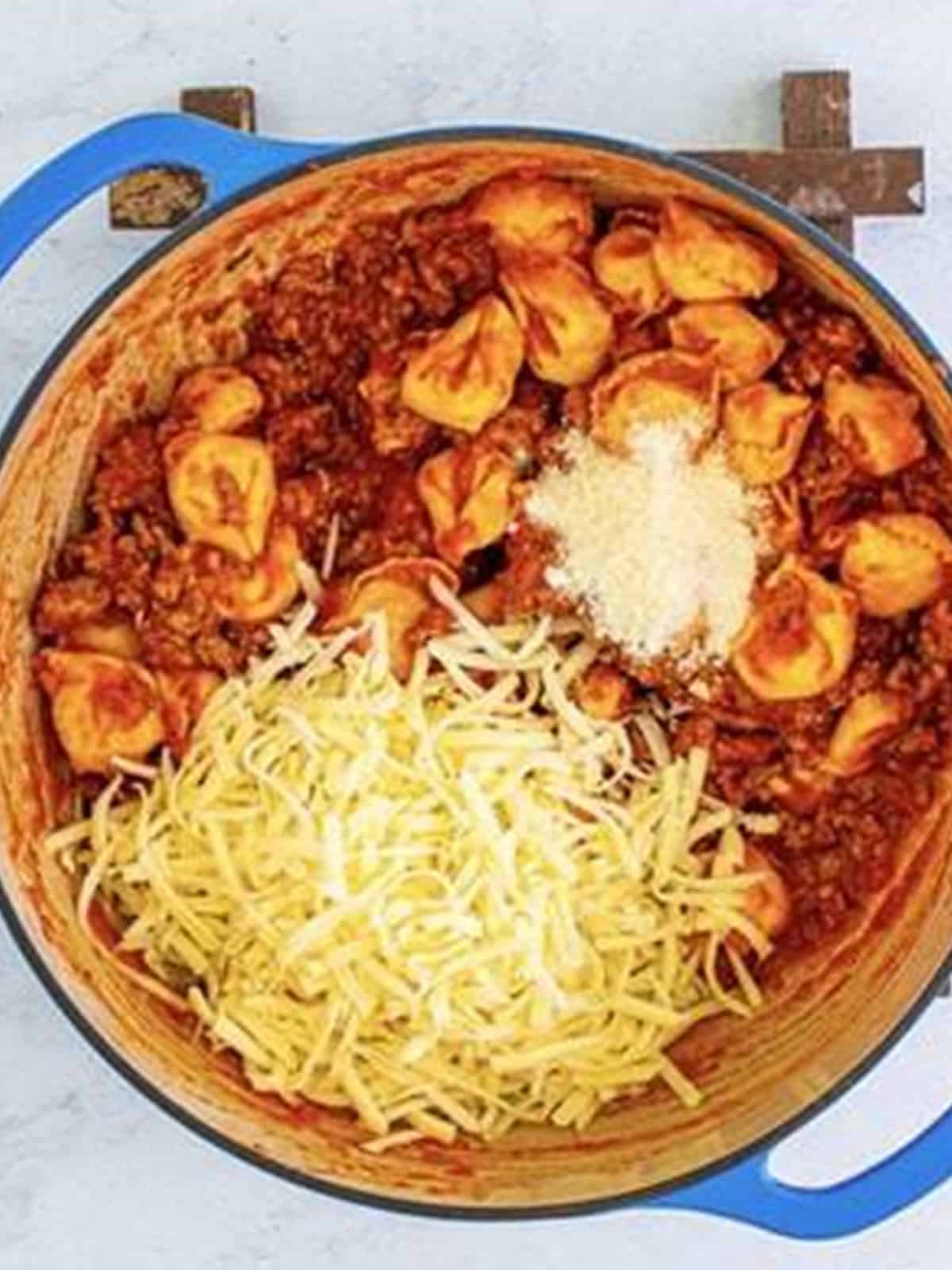 Shredded mozzarella and parmesan stirred into the tortellini and meat sauce.