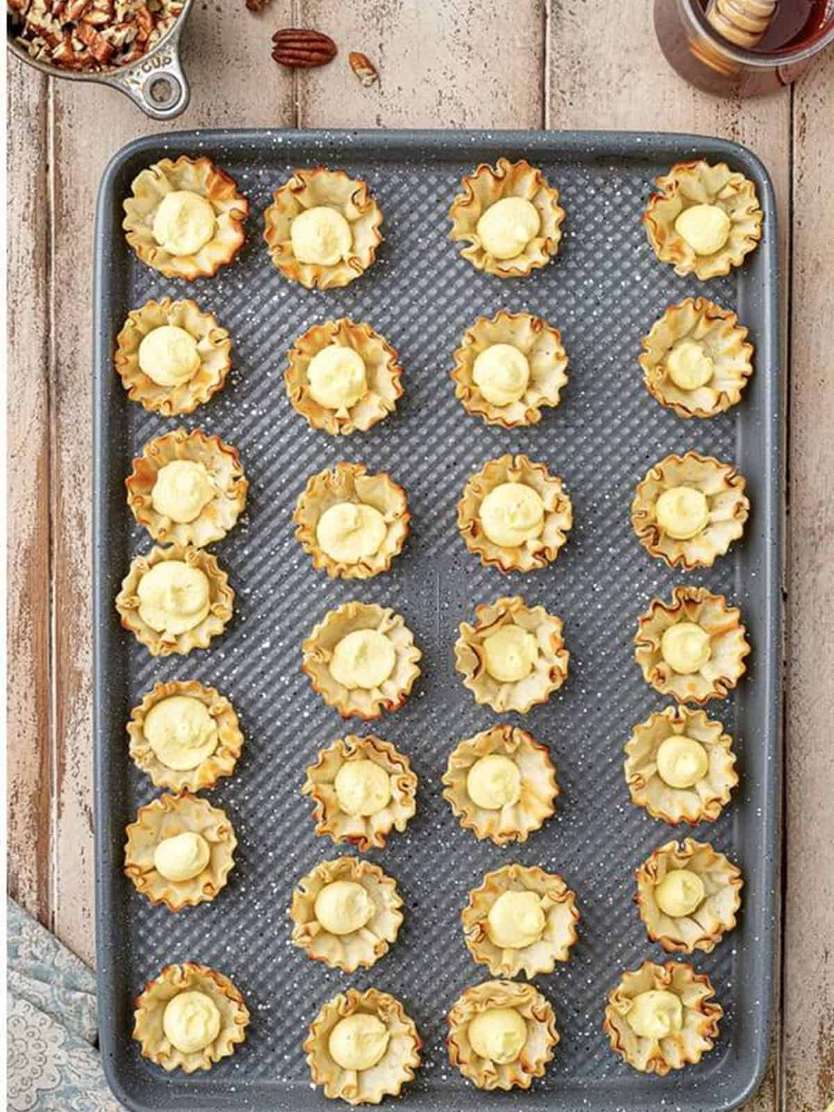 Piping the cream filling into mini phyllo cups for Baklava Bites.
