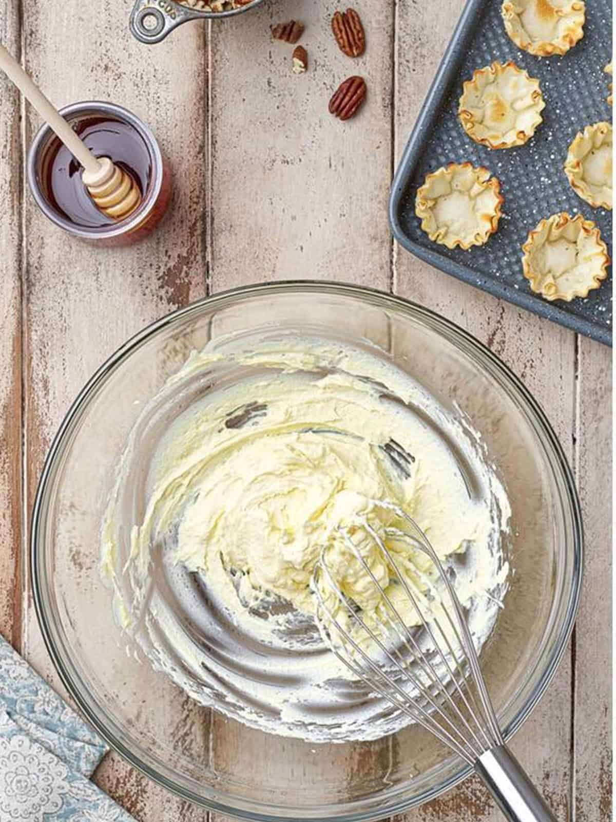 Whipping the cream and pudding to stiff peaks for Baklava Bites.