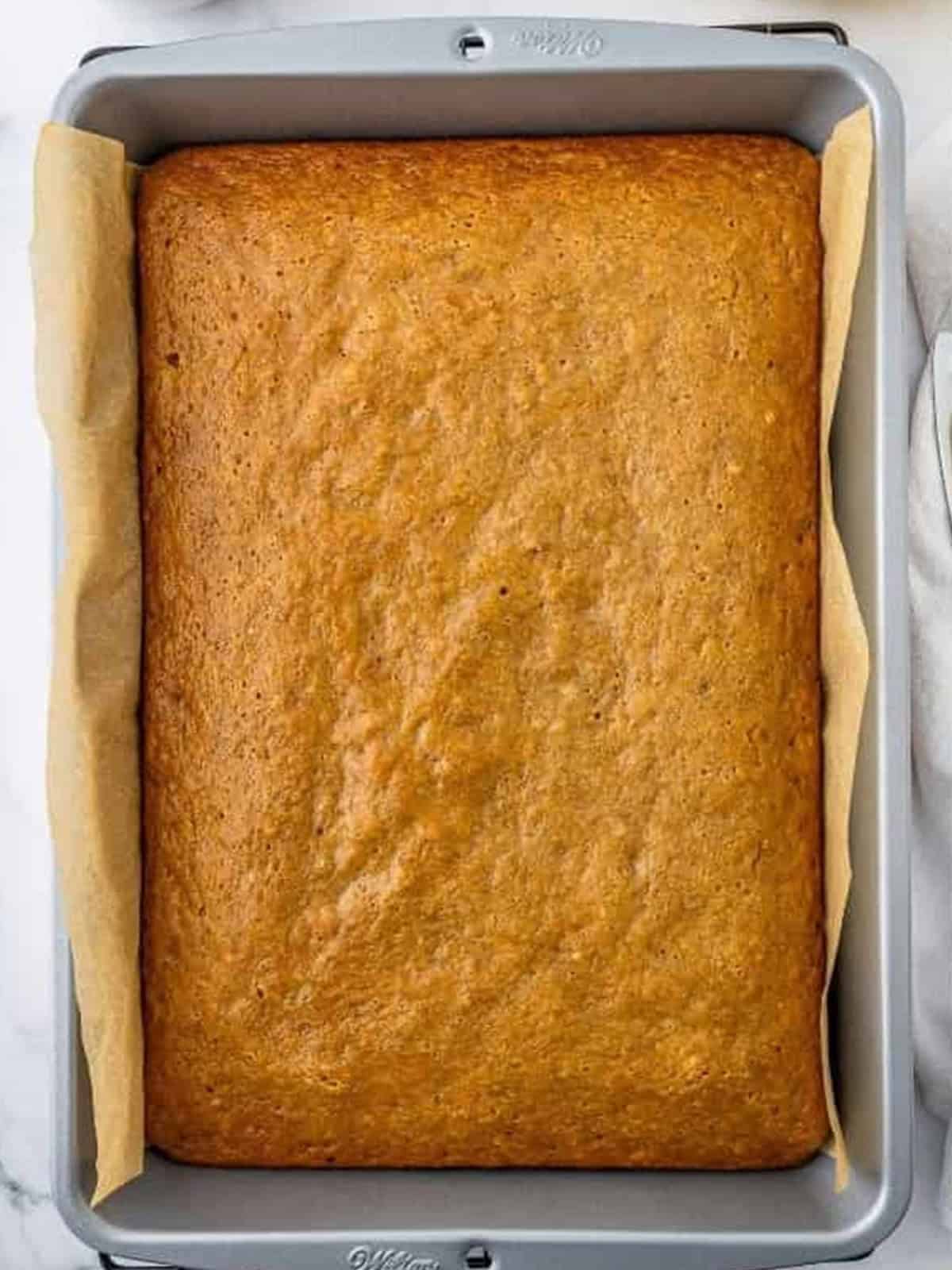 Baked banana bars cooling in a metal baking pan.