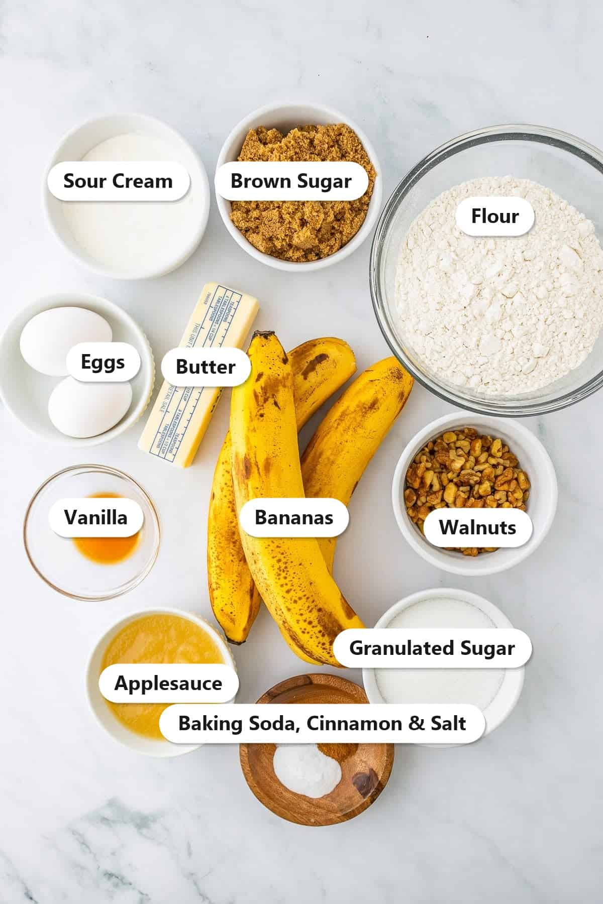 Labeled banana bars ingredients including ripe bananas, flour, sugars, sour cream, applesauce, and walnuts.