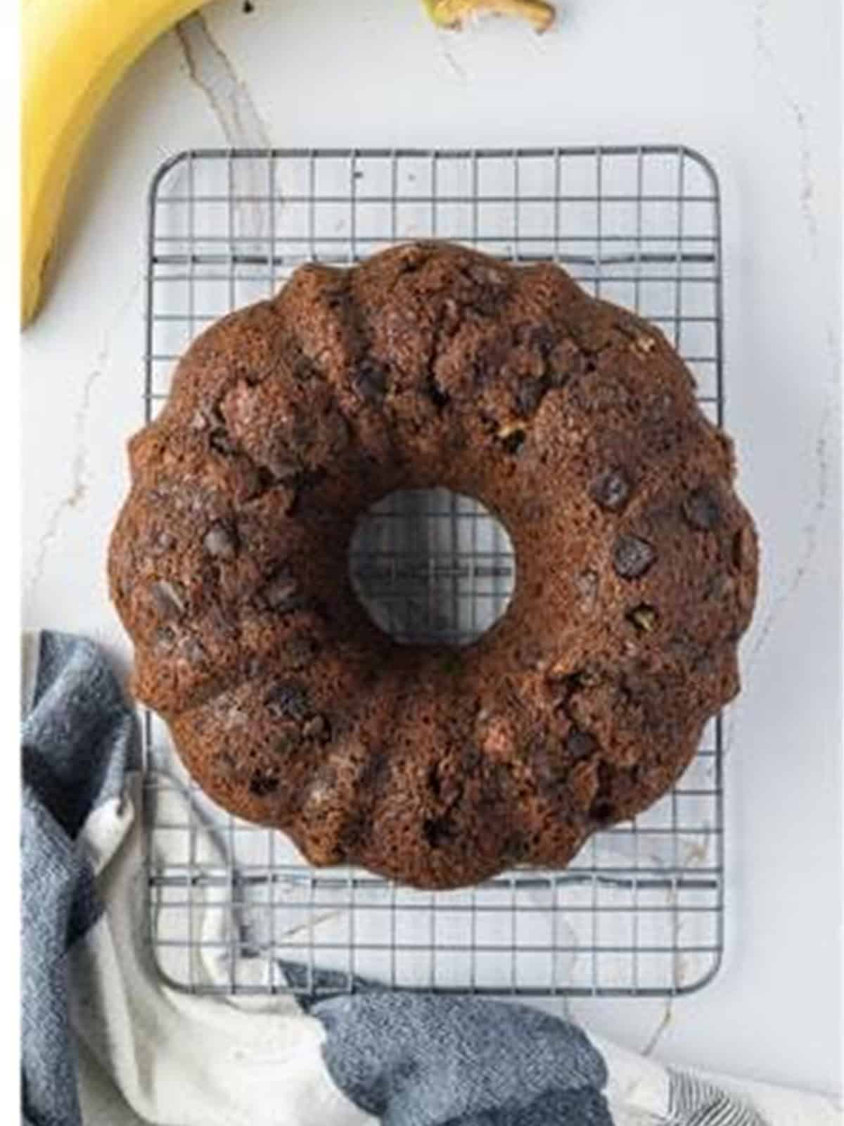 Baked banana bundt cake cooling on a wire rack.
