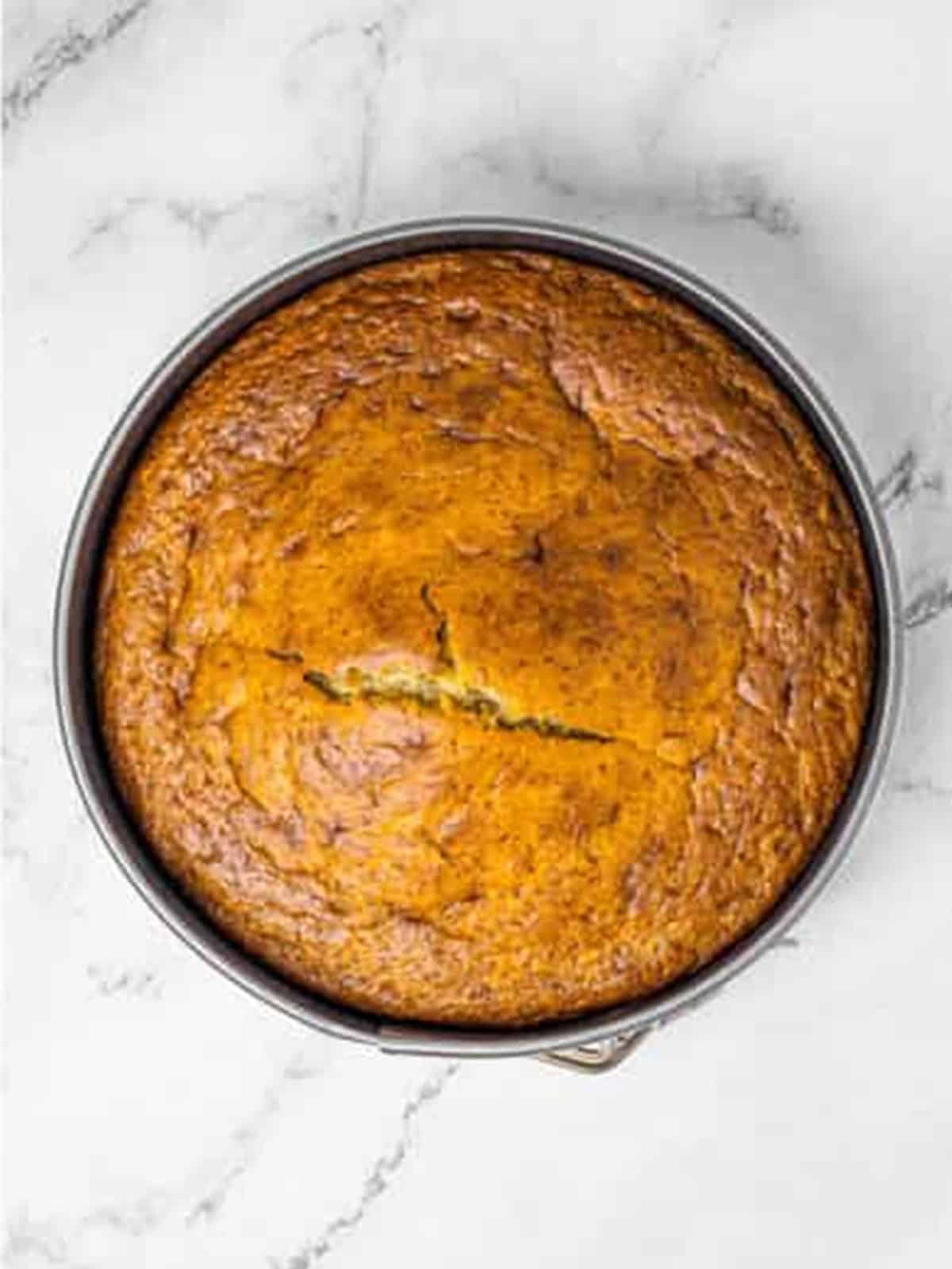 Golden baked banana cake cooling in the round pan.