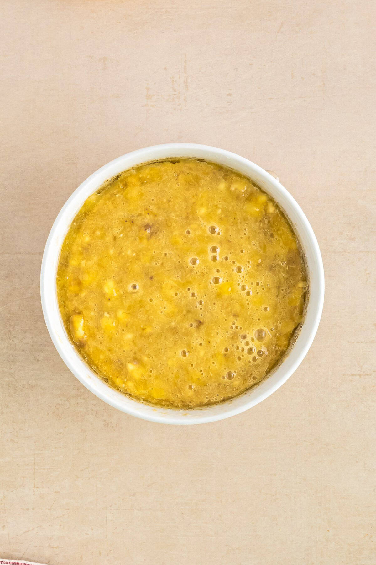Banana cupcake batter in a bowl for banana cupcakes with brown sugar frosting.