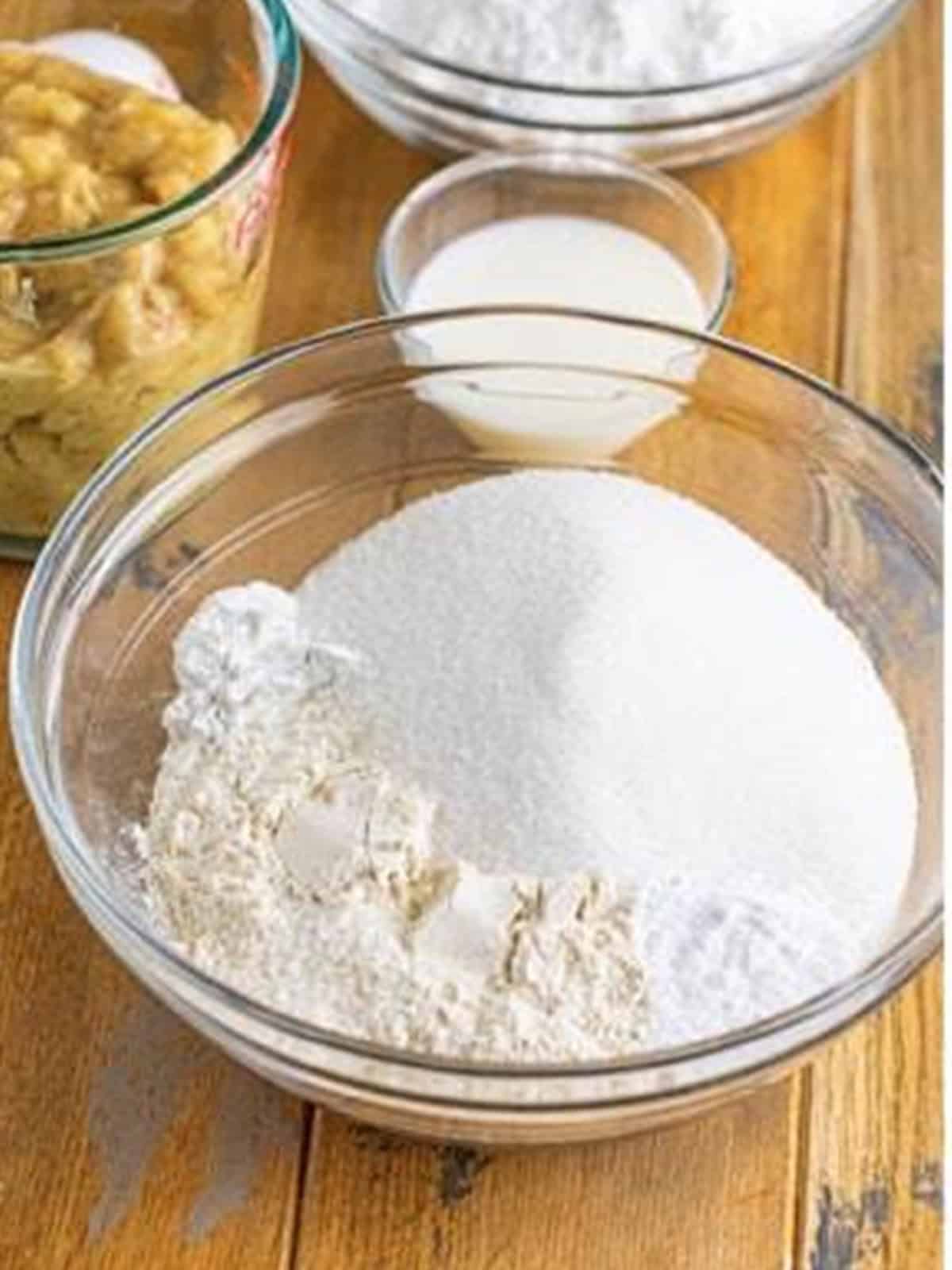 Flour, sugar, and leavening whisked together for banana donuts.
