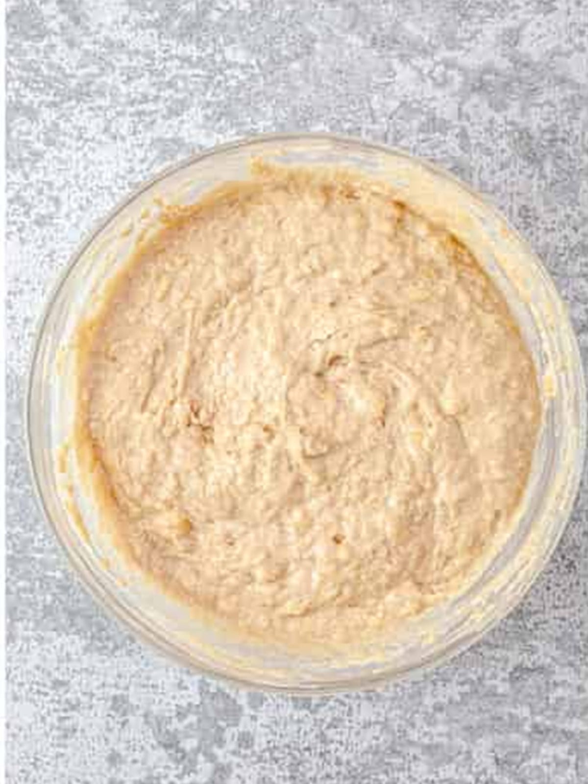 Mashed bananas, sour cream, and vanilla mixed into the banana bread batter.