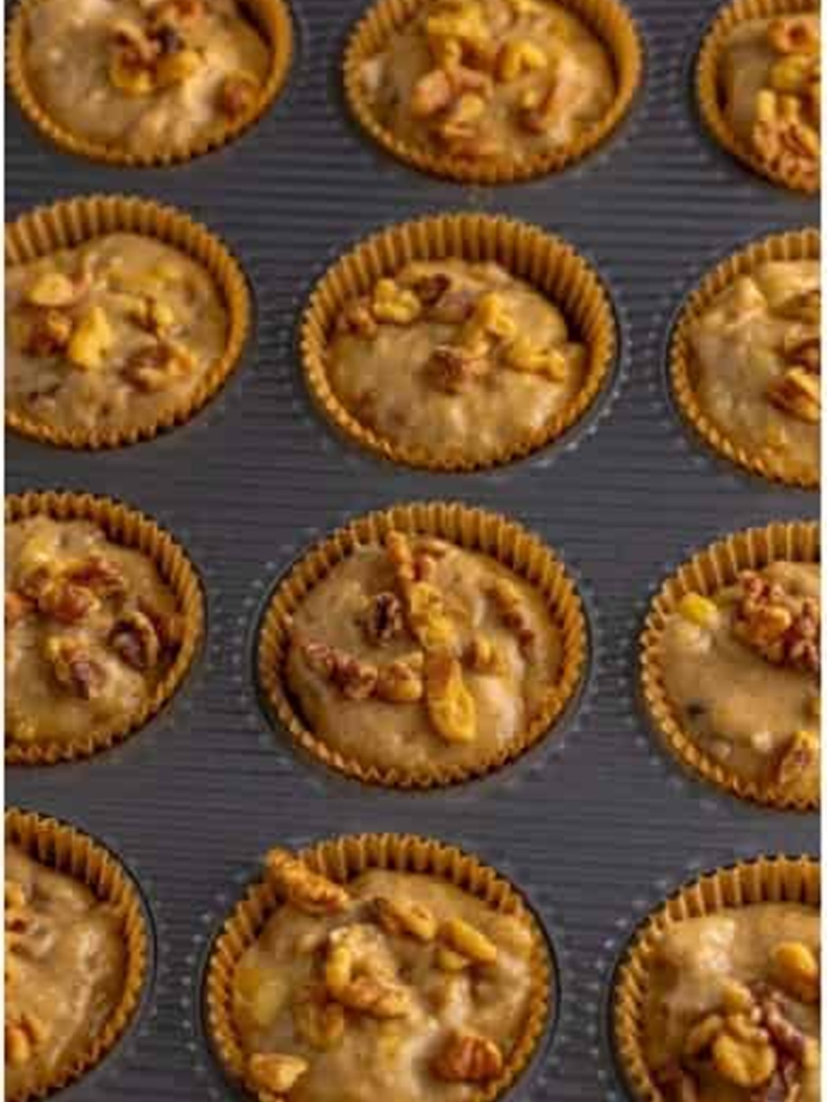 Banana nut muffin batter filled into a lined muffin tin.