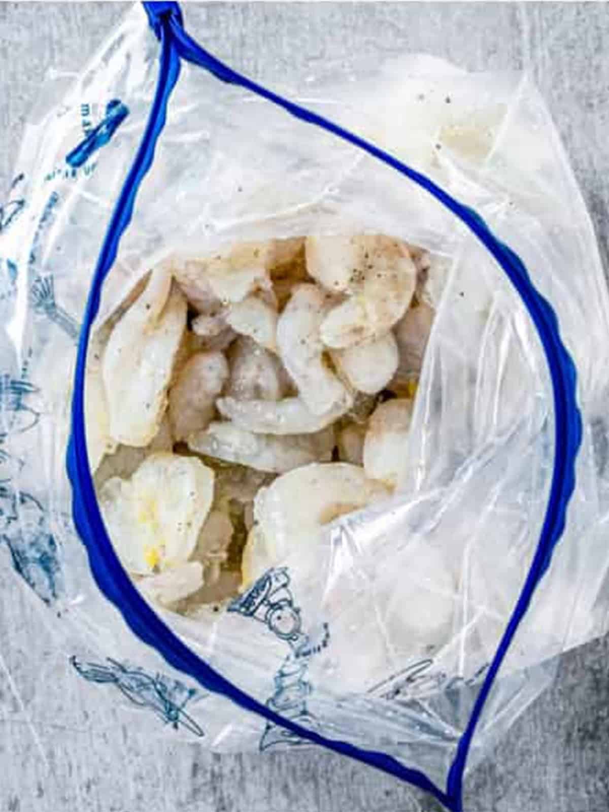 Tossing shrimp with cornstarch and seasoning in a bag.