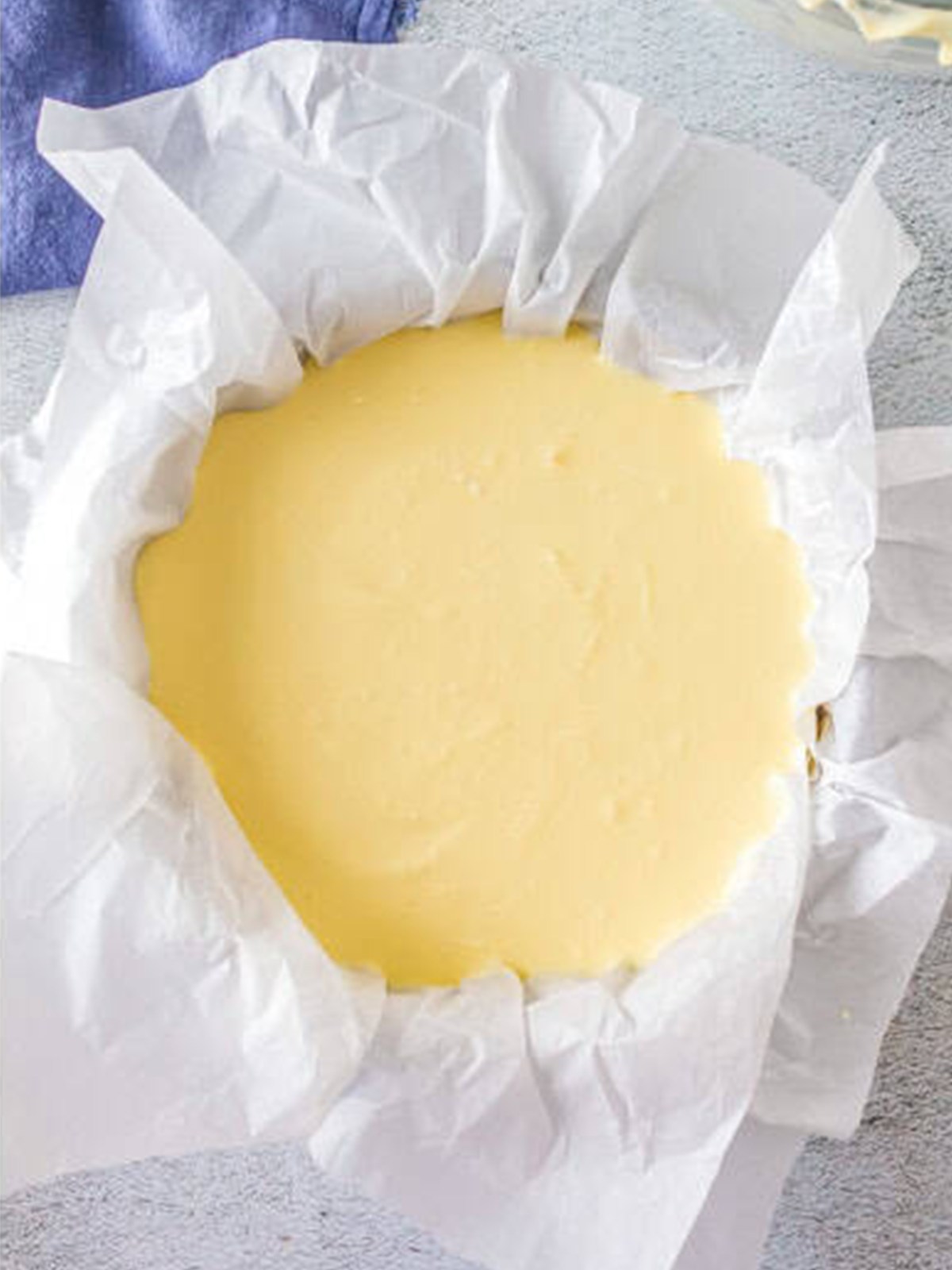 Basque cheesecake batter poured into a parchment-lined springform pan.