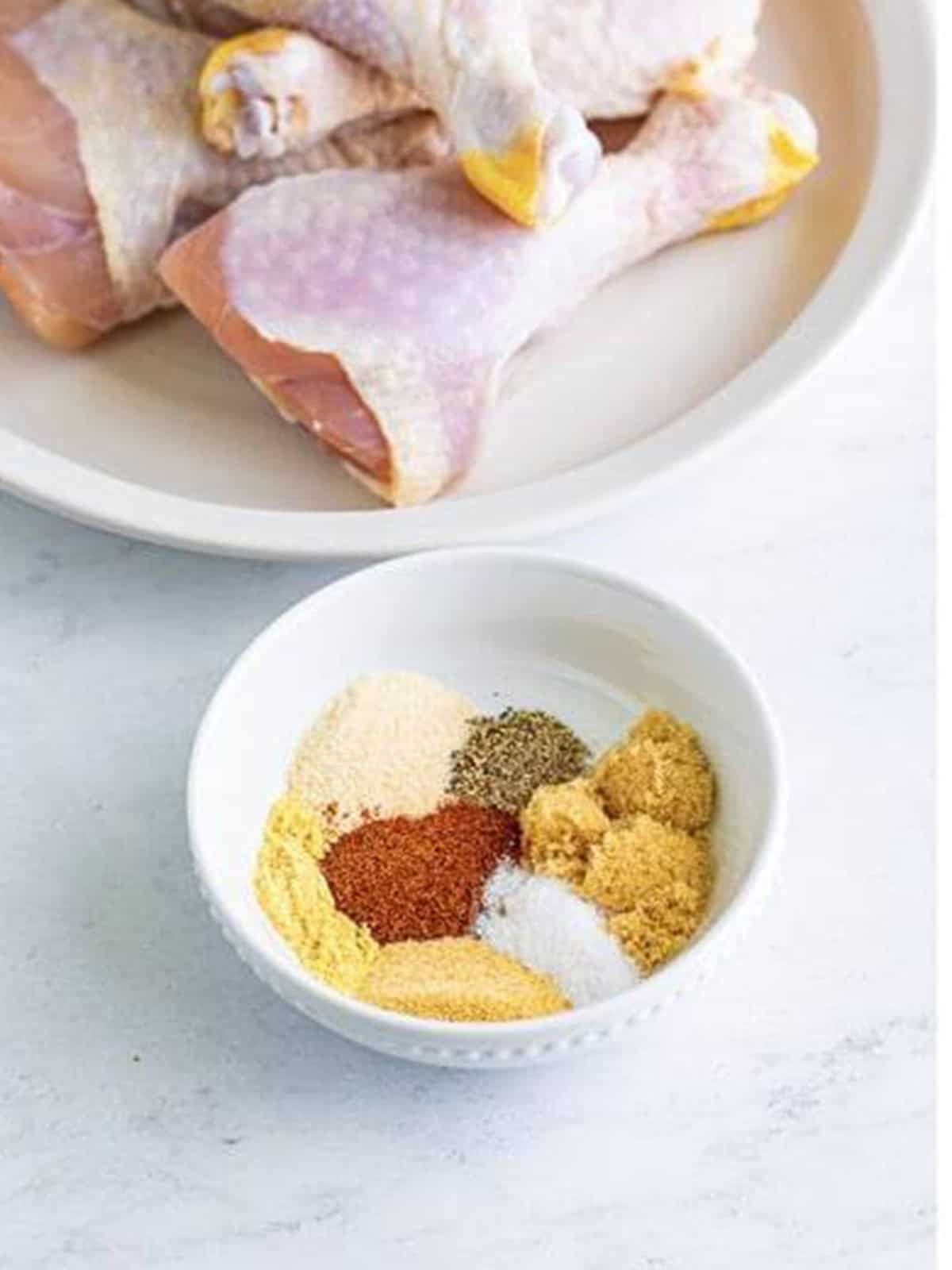 Brown sugar and spices combined into a dry rub for chicken legs.