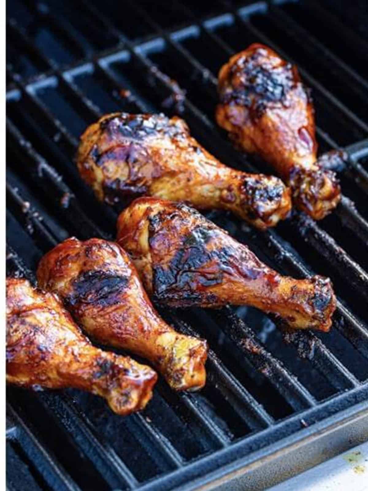 Grilled BBQ chicken legs caramelized on the grill.