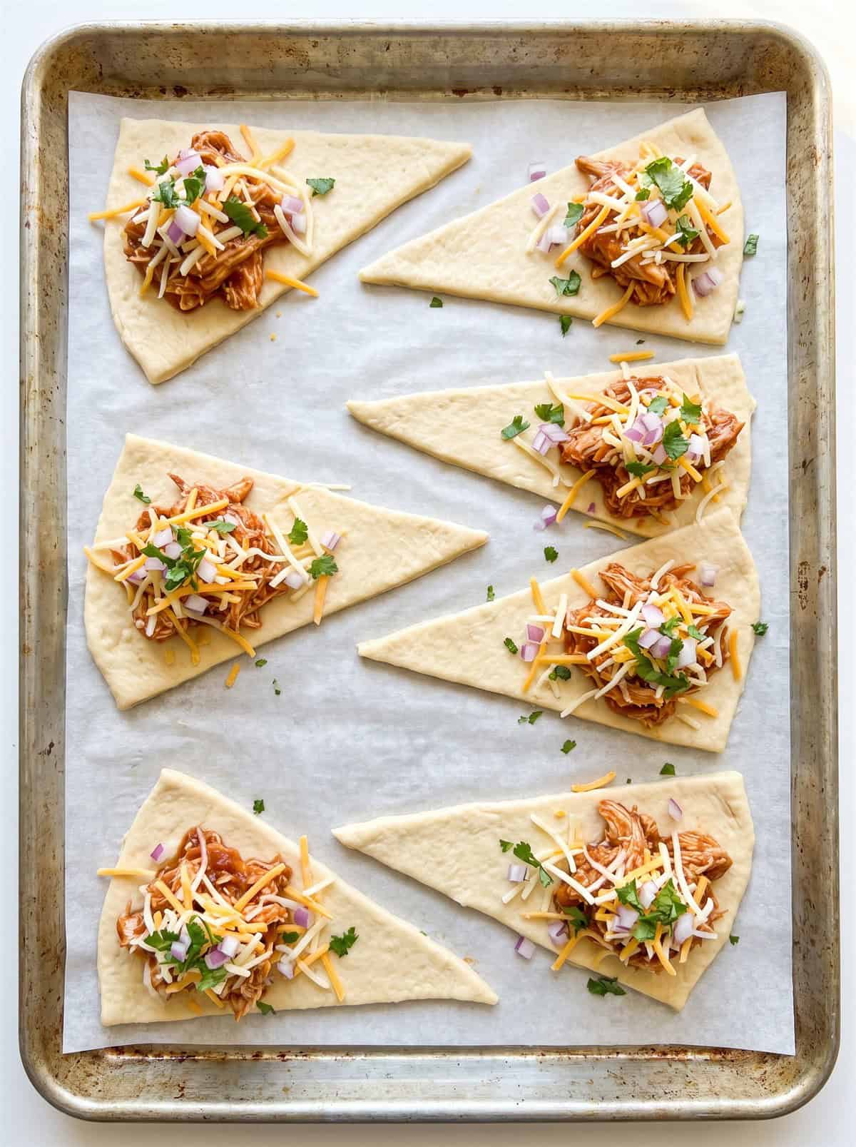 Crescent dough triangles topped with BBQ chicken, cheese, onion, and cilantro.