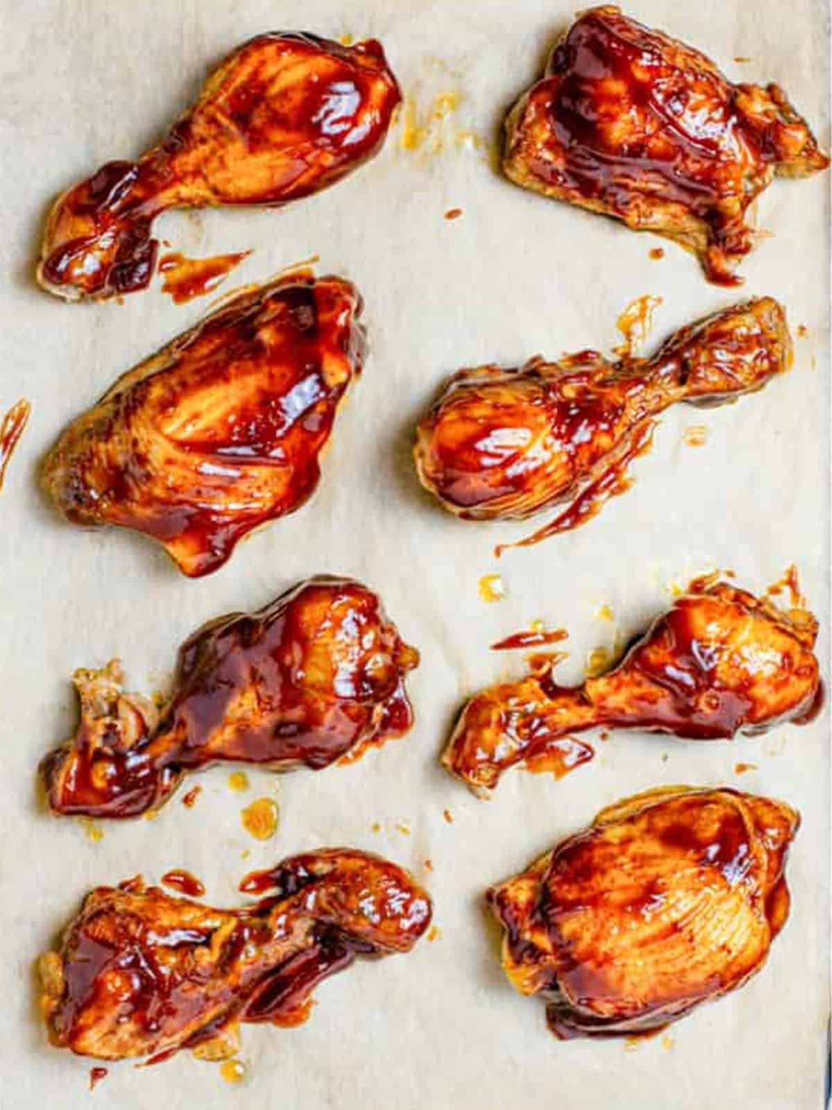 Slow cooker BBQ chicken brushed with sauce and broiled until sticky and caramelized.