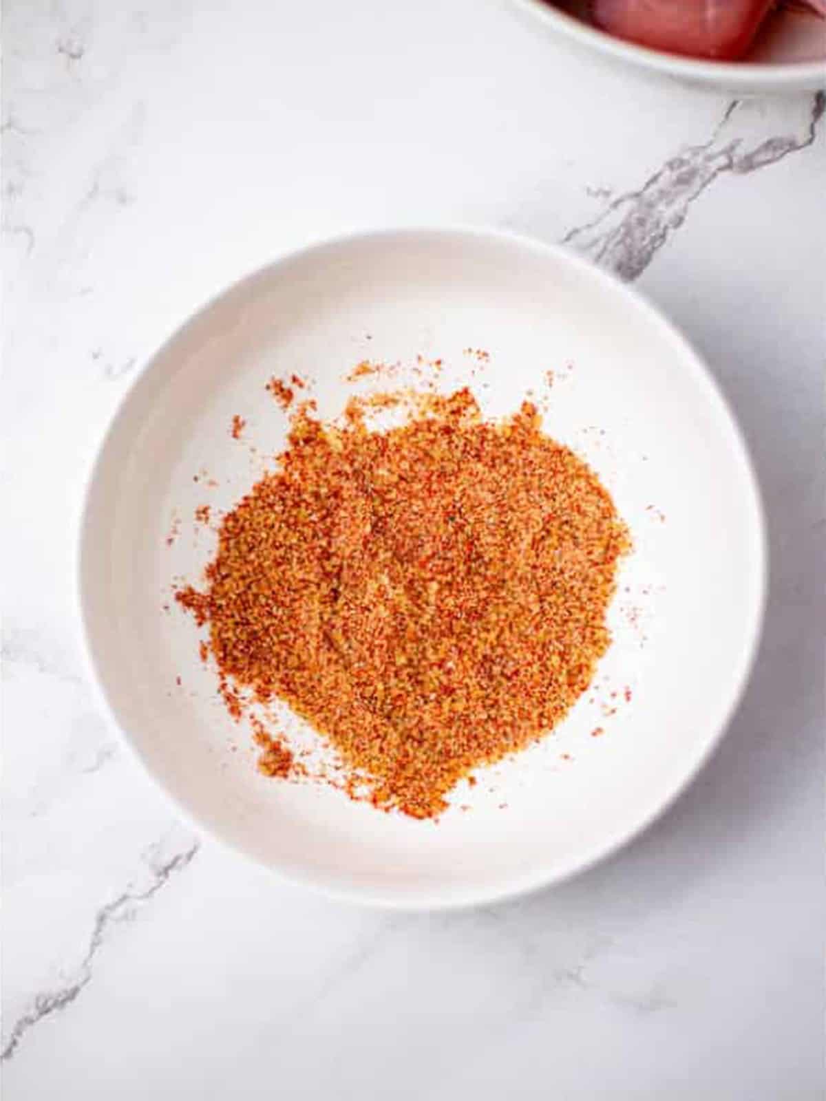 Brown sugar and spice seasoning mixed in a bowl for slow cooker BBQ chicken.