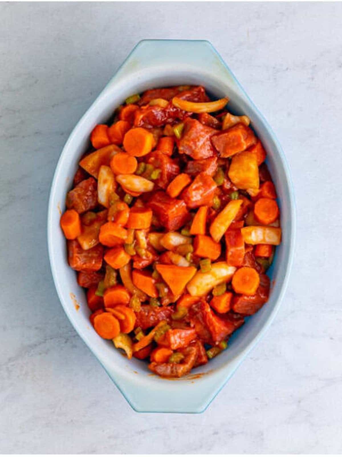 The beef stew mixture spread into a baking dish before going in the oven for beef stew recipe.