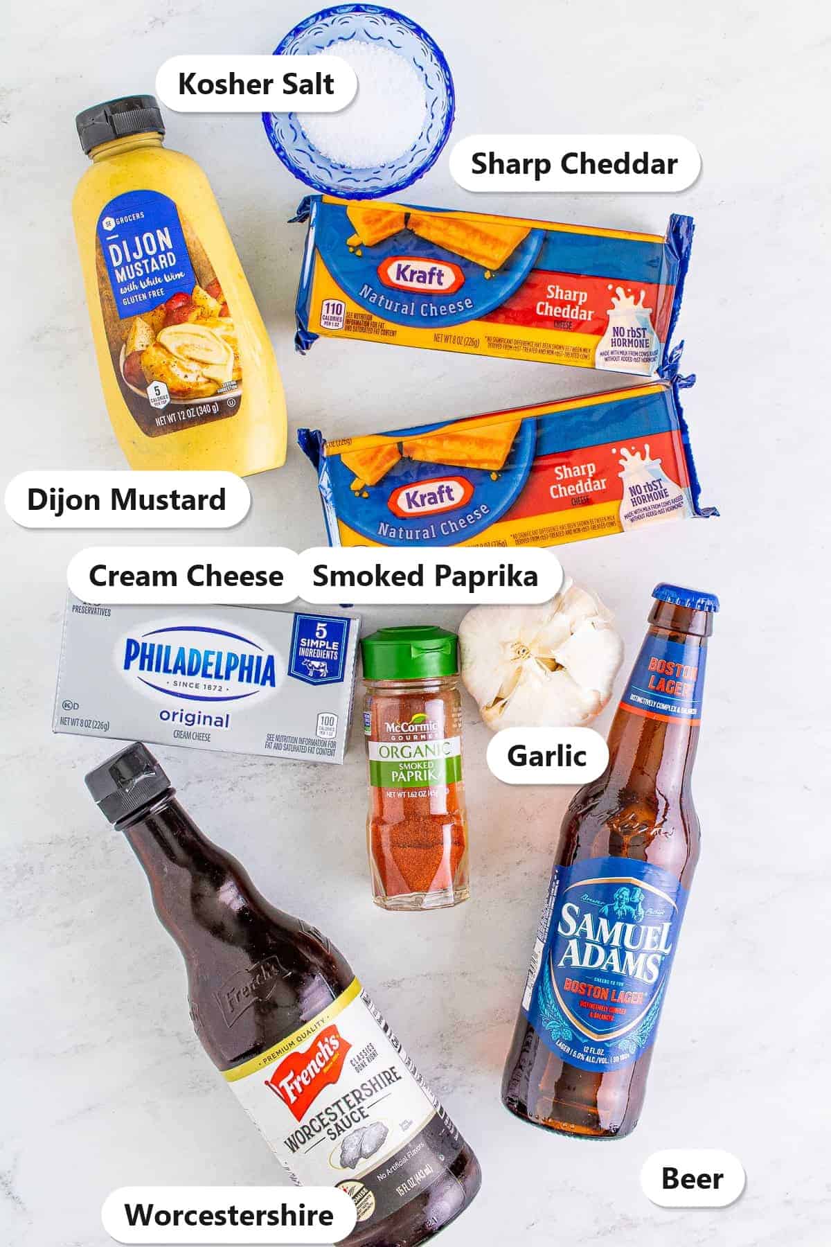 Labeled ingredients for beer cheese dip including sharp cheddar, cream cheese, beer, dijon mustard, Worcestershire, smoked paprika, garlic, and kosher salt.