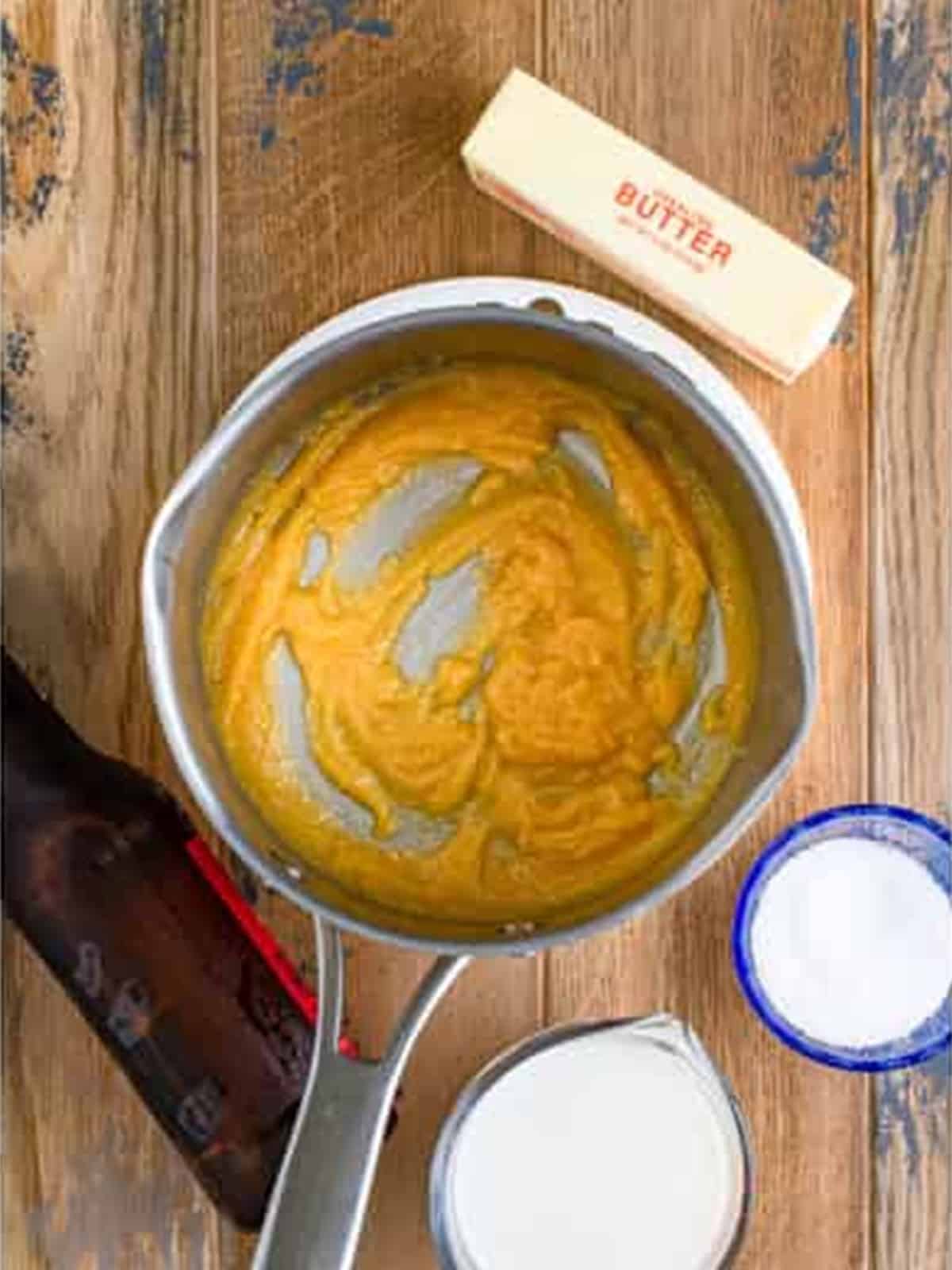 A cooked golden roux in a saucepan for beer cheese dip.