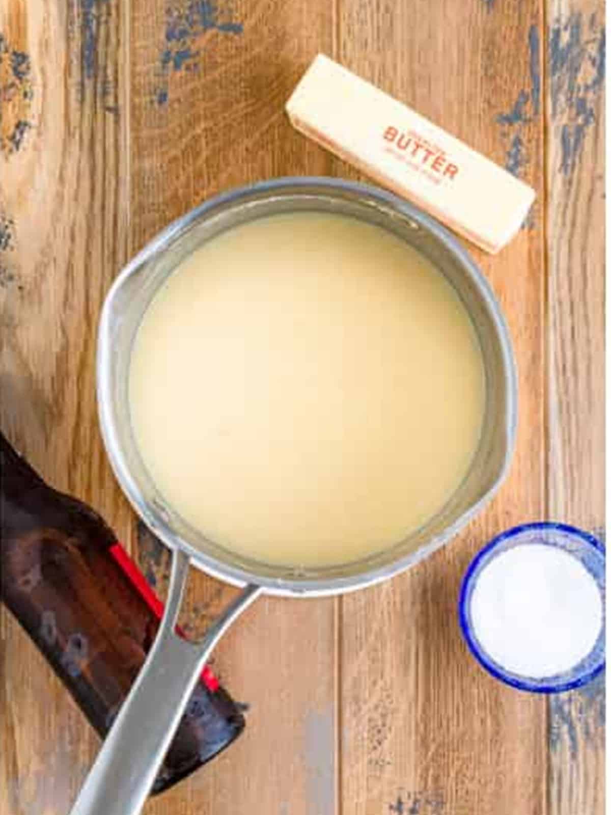 Smooth melted beer cheese dip in a saucepan ready to serve.