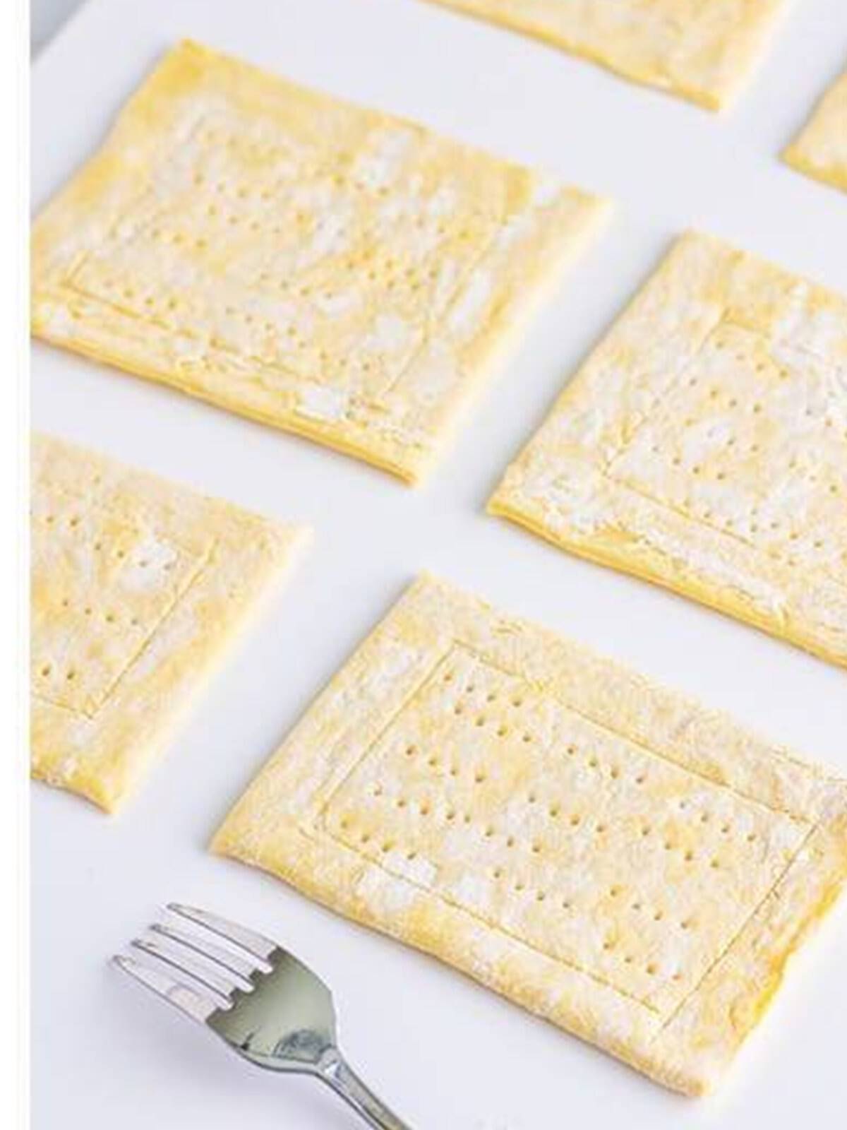 Puff pastry cut into rectangles and scored with a border to make berry danish.