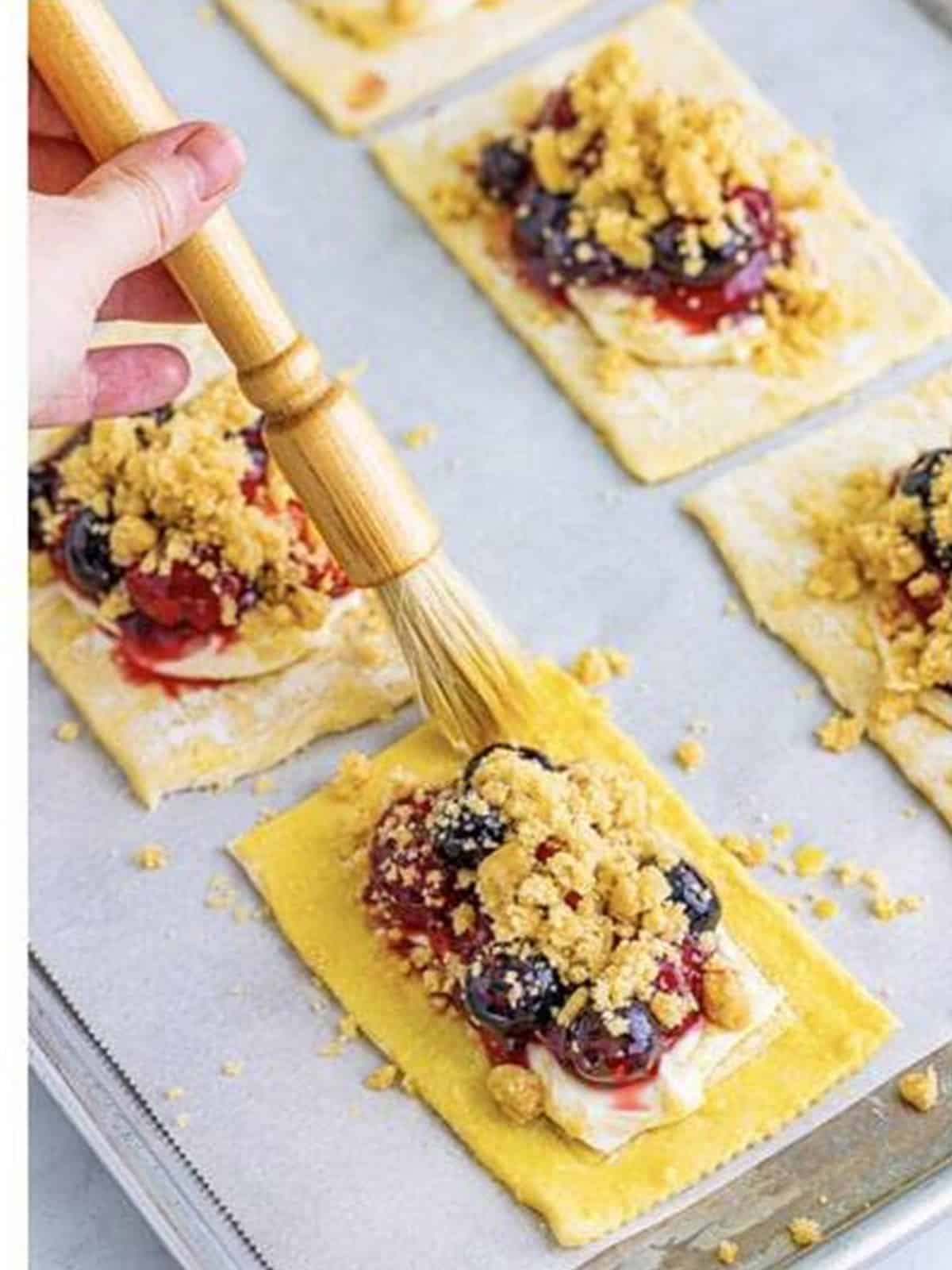 Crumble topping added over the berries on each berry danish.