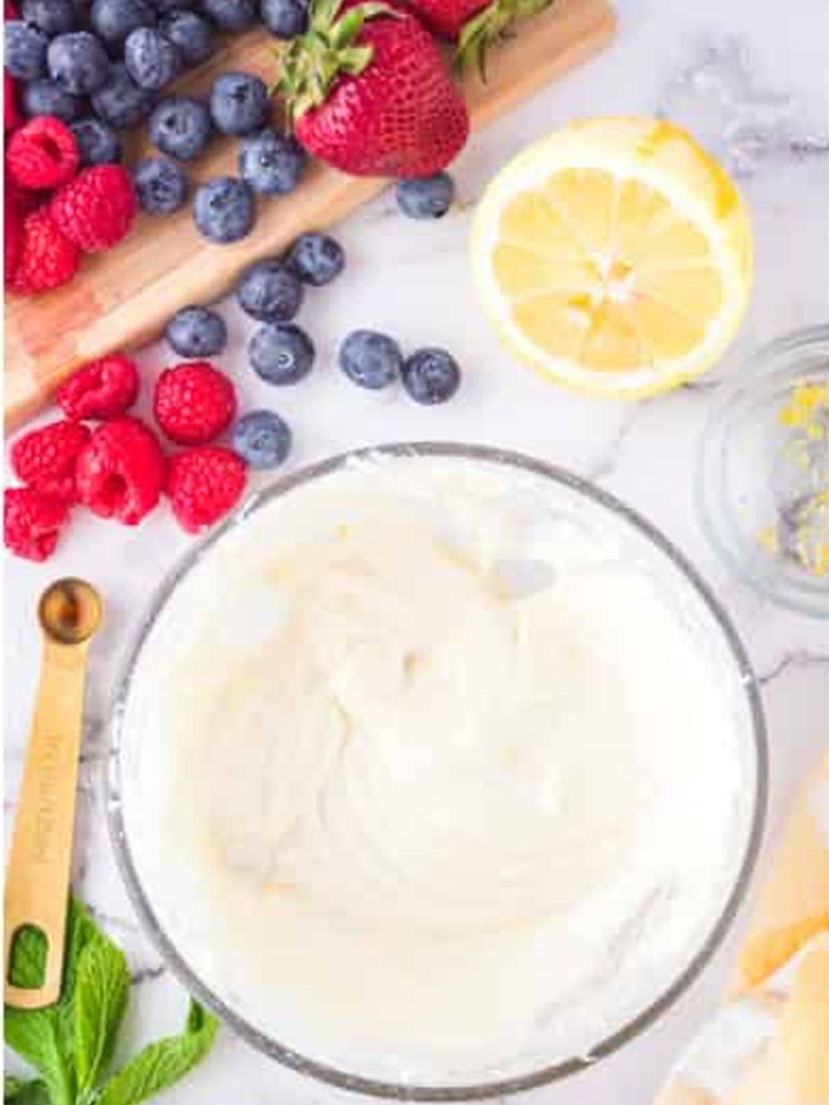 Whipped smooth cream cheese filling in a glass bowl.