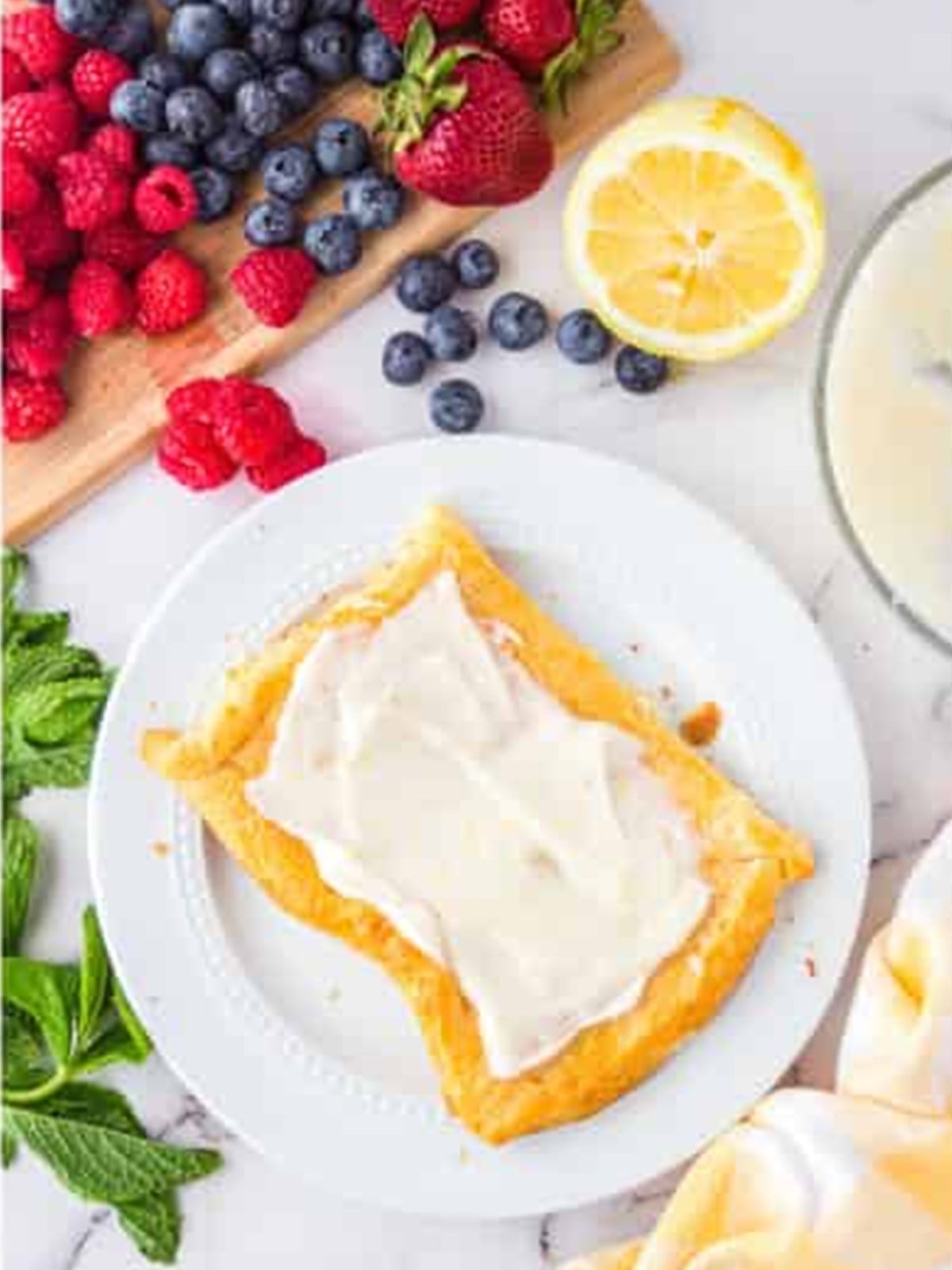 Cream cheese filling spread over a baked tart shell.