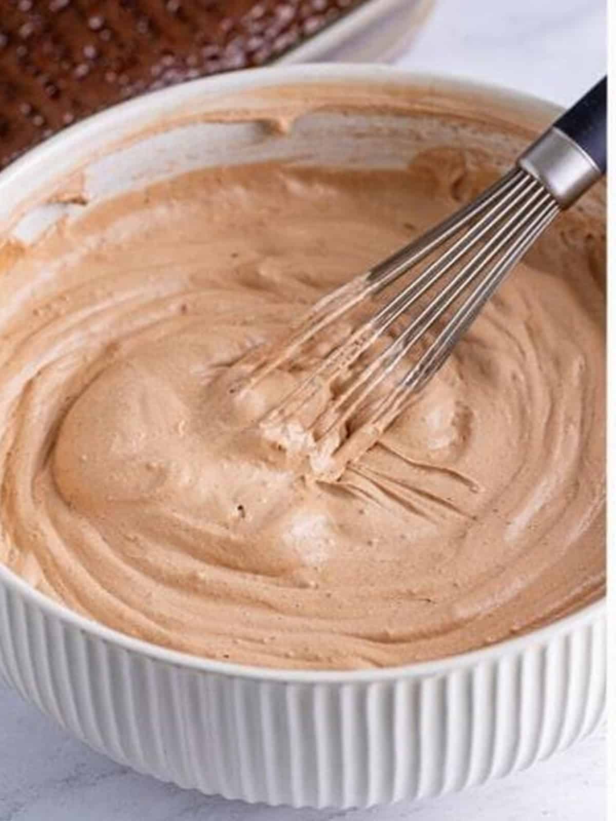 Whisking chocolate pudding whipped topping in a bowl