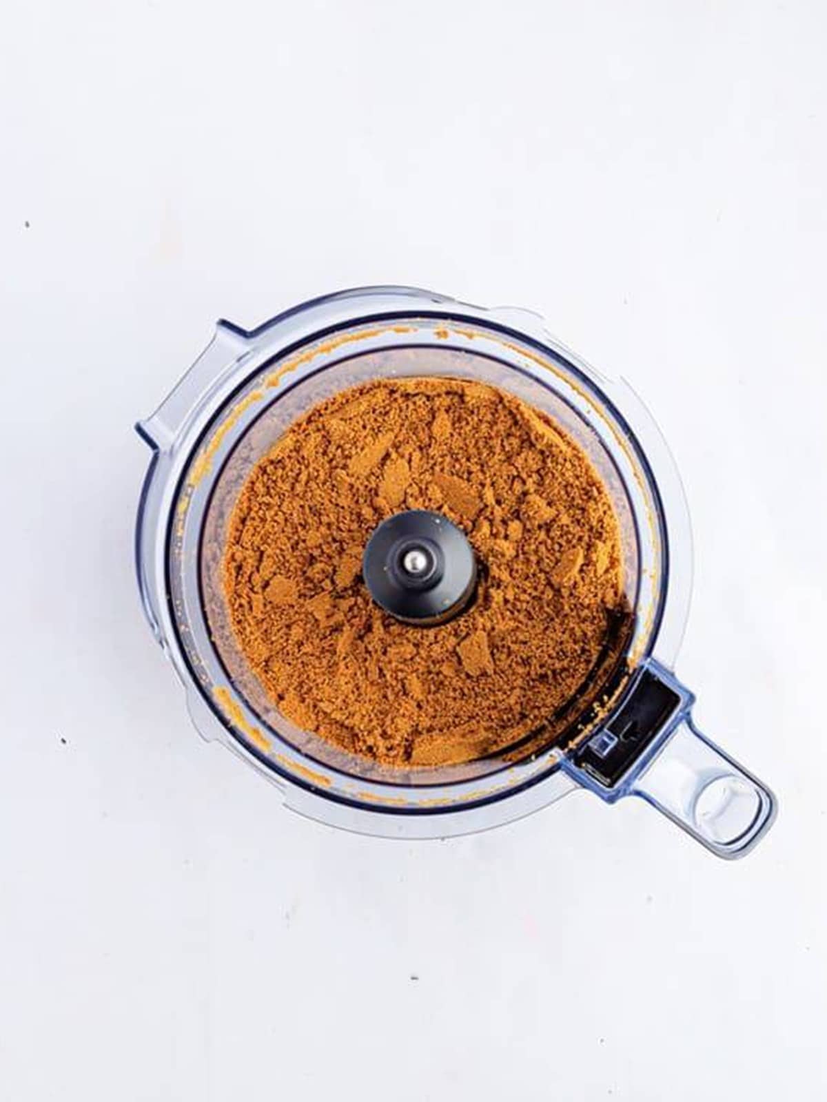 Biscoff cookies blitzed into fine crumbs in a food processor for the cheesecake bar crust.