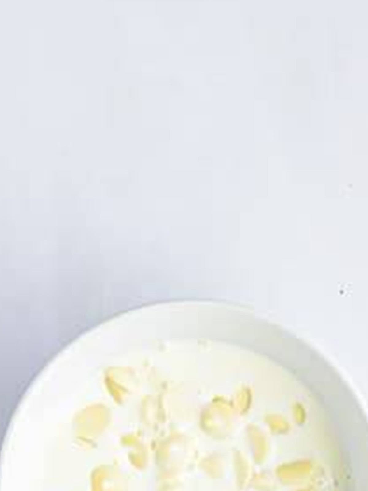 White chocolate chips and cream in a bowl to make the ganache topping.