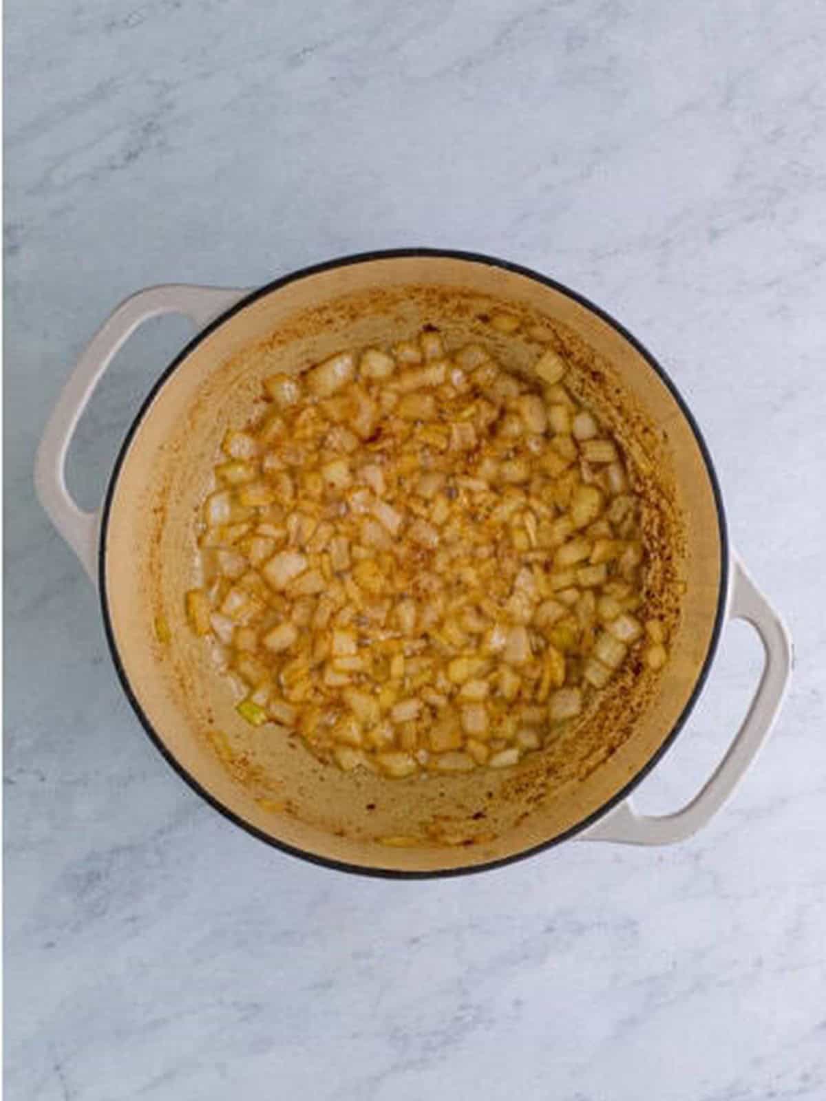 Black eyed peas and chicken stock simmering in a dutch oven.