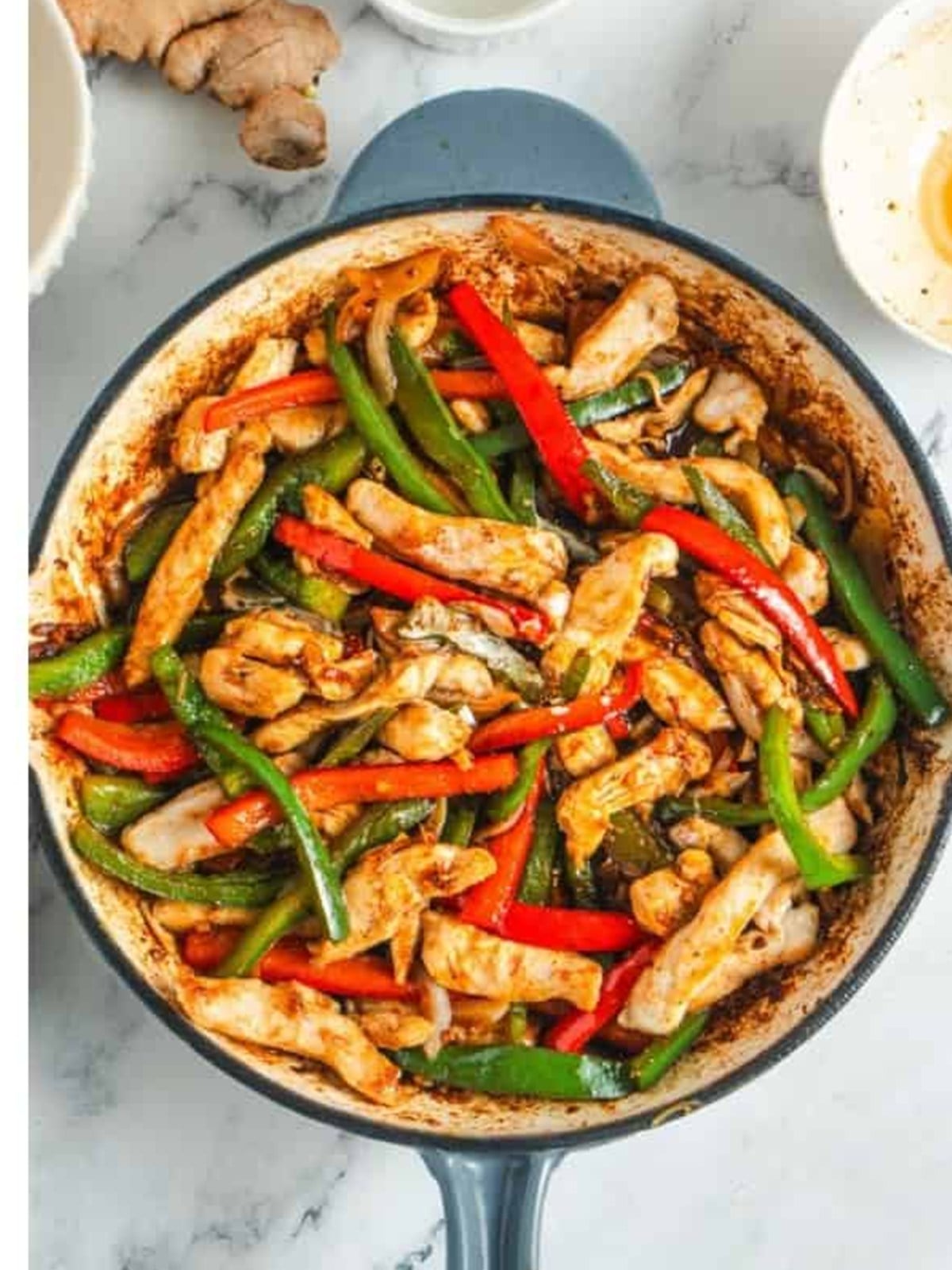Finished black pepper chicken with a glossy thickened sauce coating the chicken and peppers.