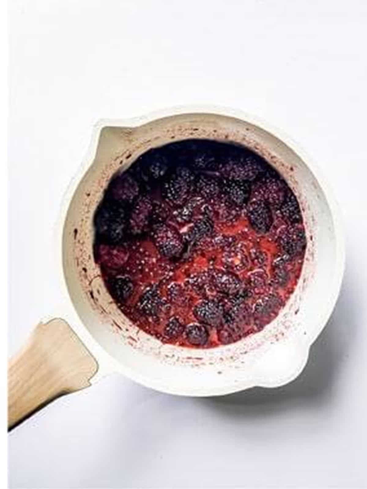 Fresh blackberries with sugar and cornstarch in a saucepan.