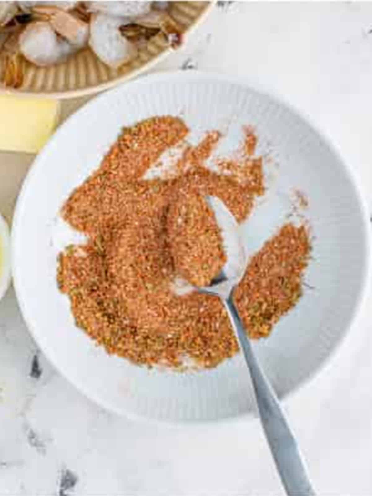 Mixing the blackening seasoning of paprika, garlic, onion, brown sugar, and herbs for Blackened Shrimp.