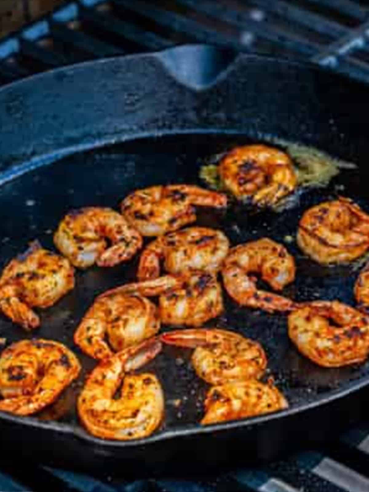 Searing the seasoned shrimp in a hot cast iron skillet for Blackened Shrimp.