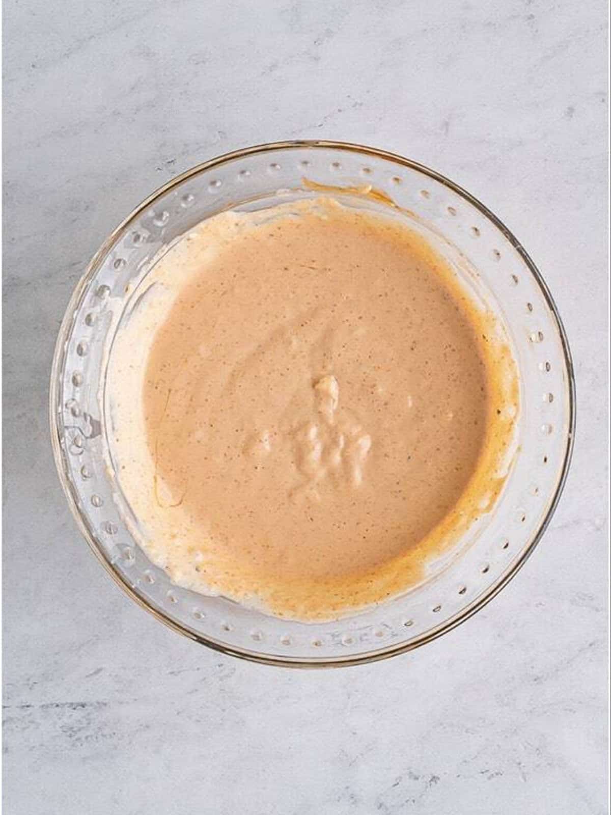 Bloomin Onion Sauce whisked smooth and creamy in a glass bowl.