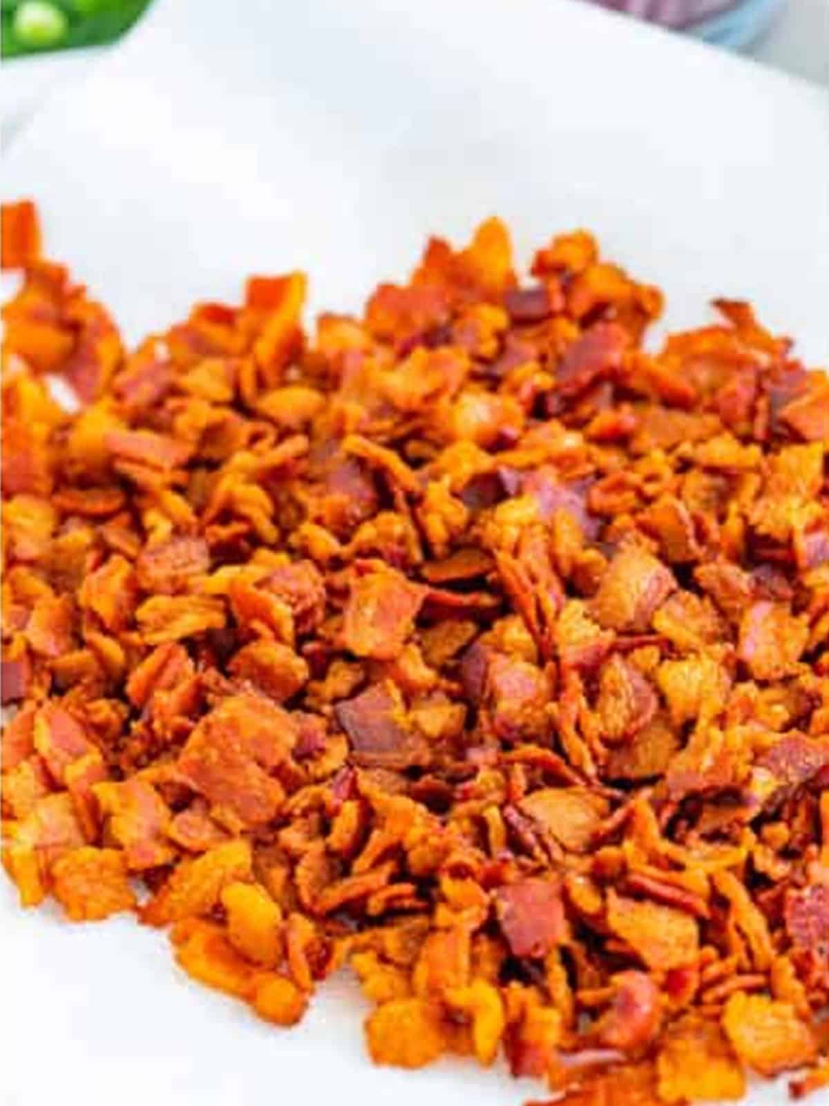 Crispy diced bacon drained on a paper towel for BLT Pasta Salad.