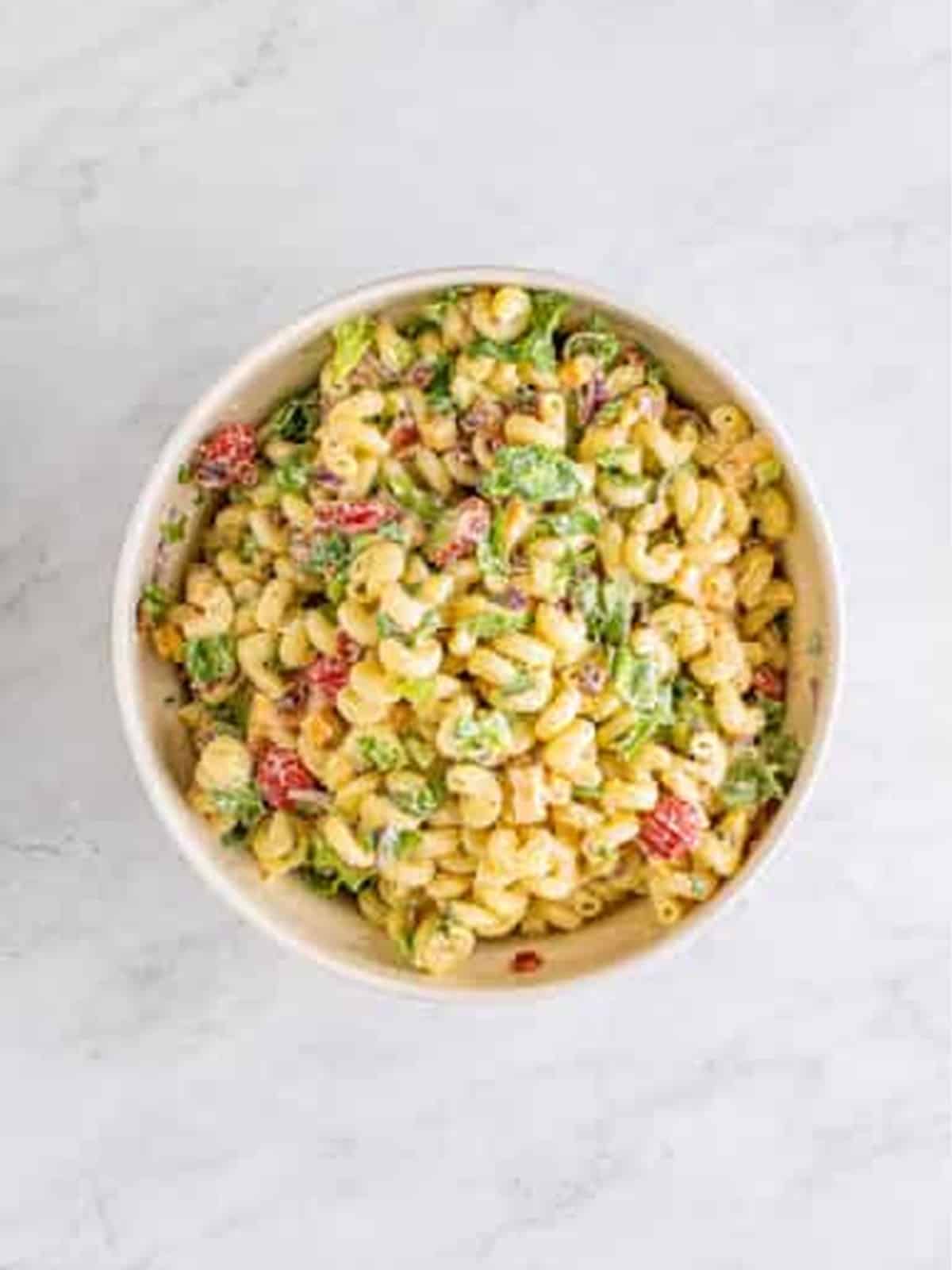 Finished BLT Pasta Salad tossed together with bacon, lettuce, and tomatoes.